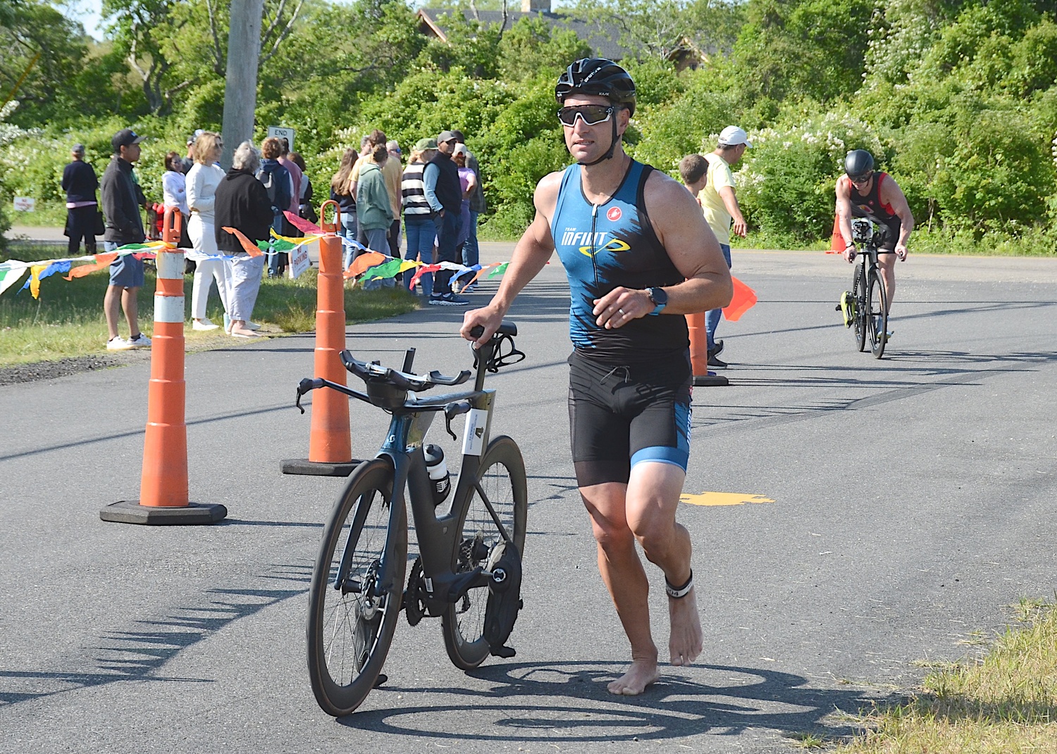 Triathletes make the transition from the bike to the run portion.   KYRIL BROMLEY