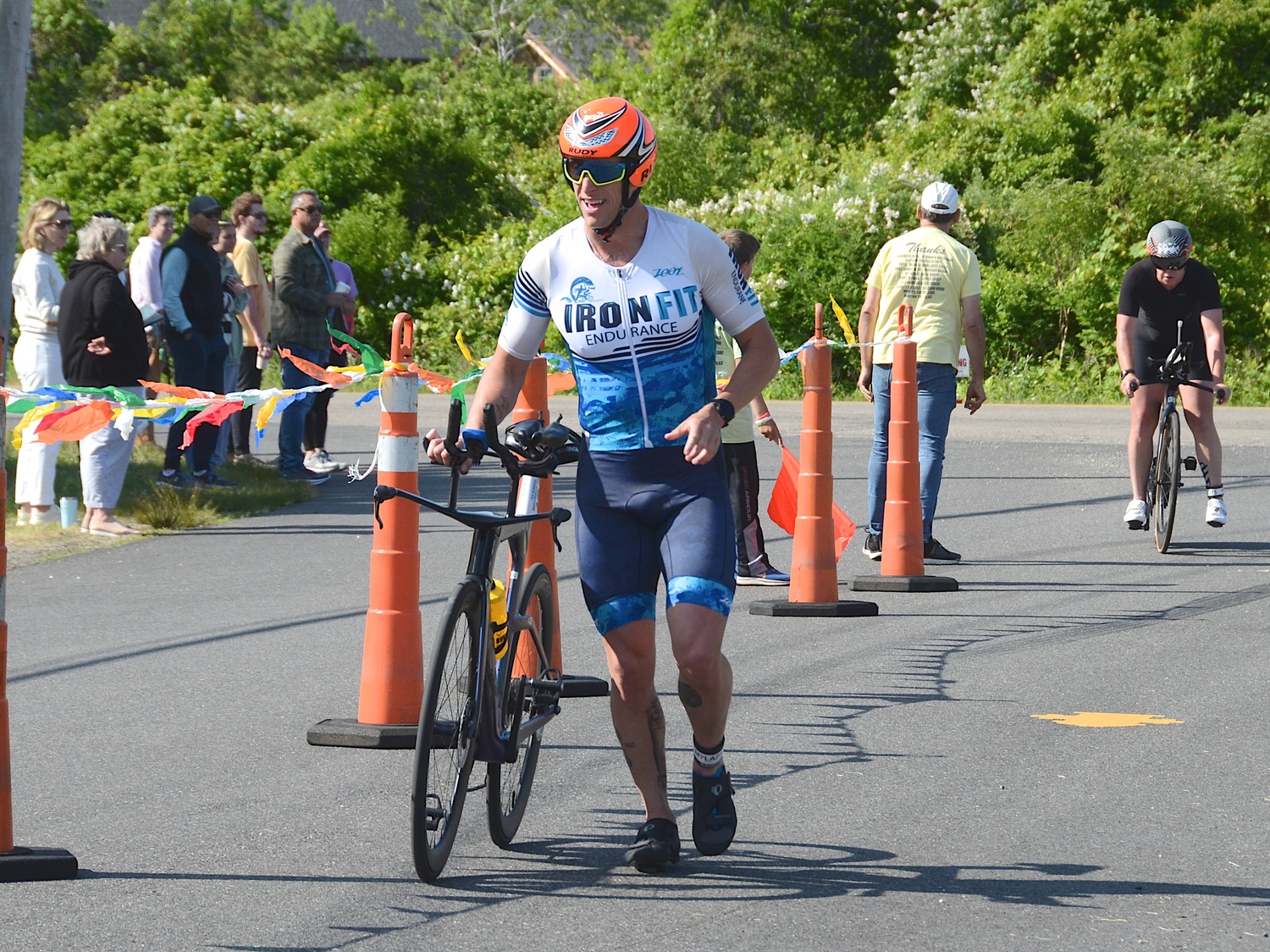 Triathletes make the transition from the bike to the run portion.   KYRIL BROMLEY