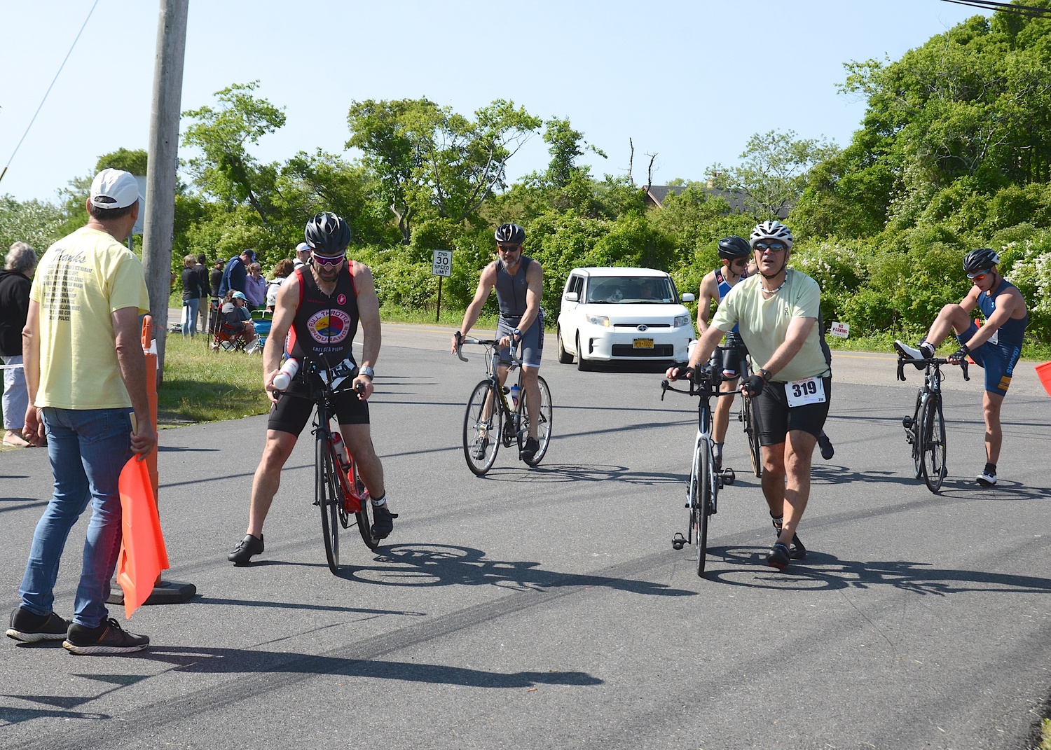 Triathletes make the transition from the bike to the run portion.   KYRIL BROMLEY