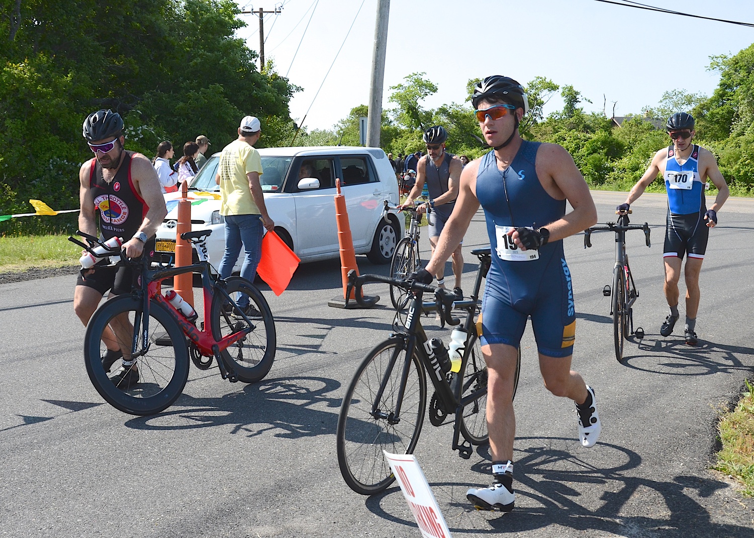 Triathletes make the transition from the bike to the run portion.   KYRIL BROMLEY