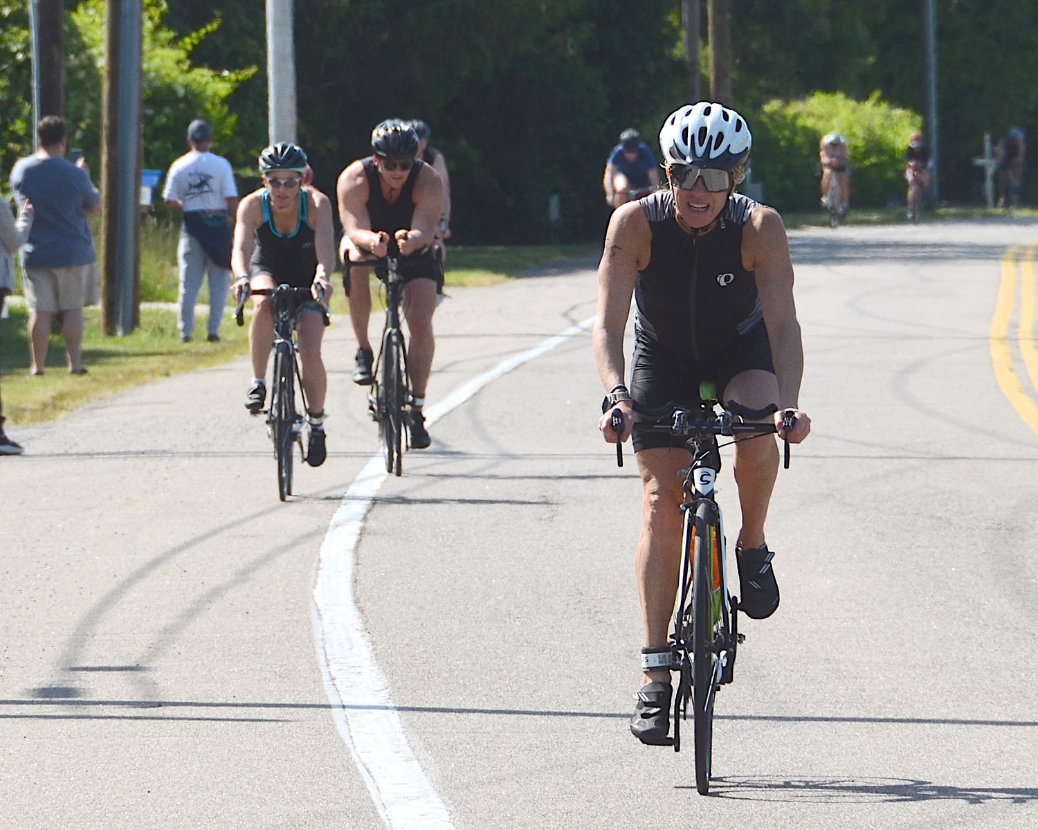 Triathletes make the transition from the bike to the run portion.   KYRIL BROMLEY