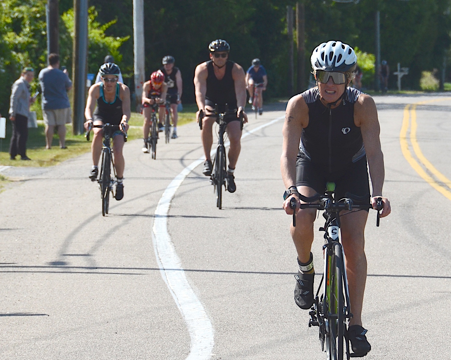 Triathletes make the transition from the bike to the run portion.   KYRIL BROMLEY