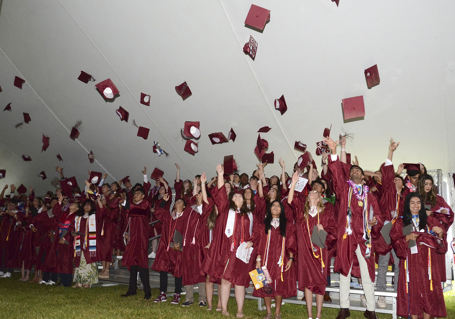 Graduates toss their caps at East Hampton High School on Friday night.  KYRIL BROMLEY