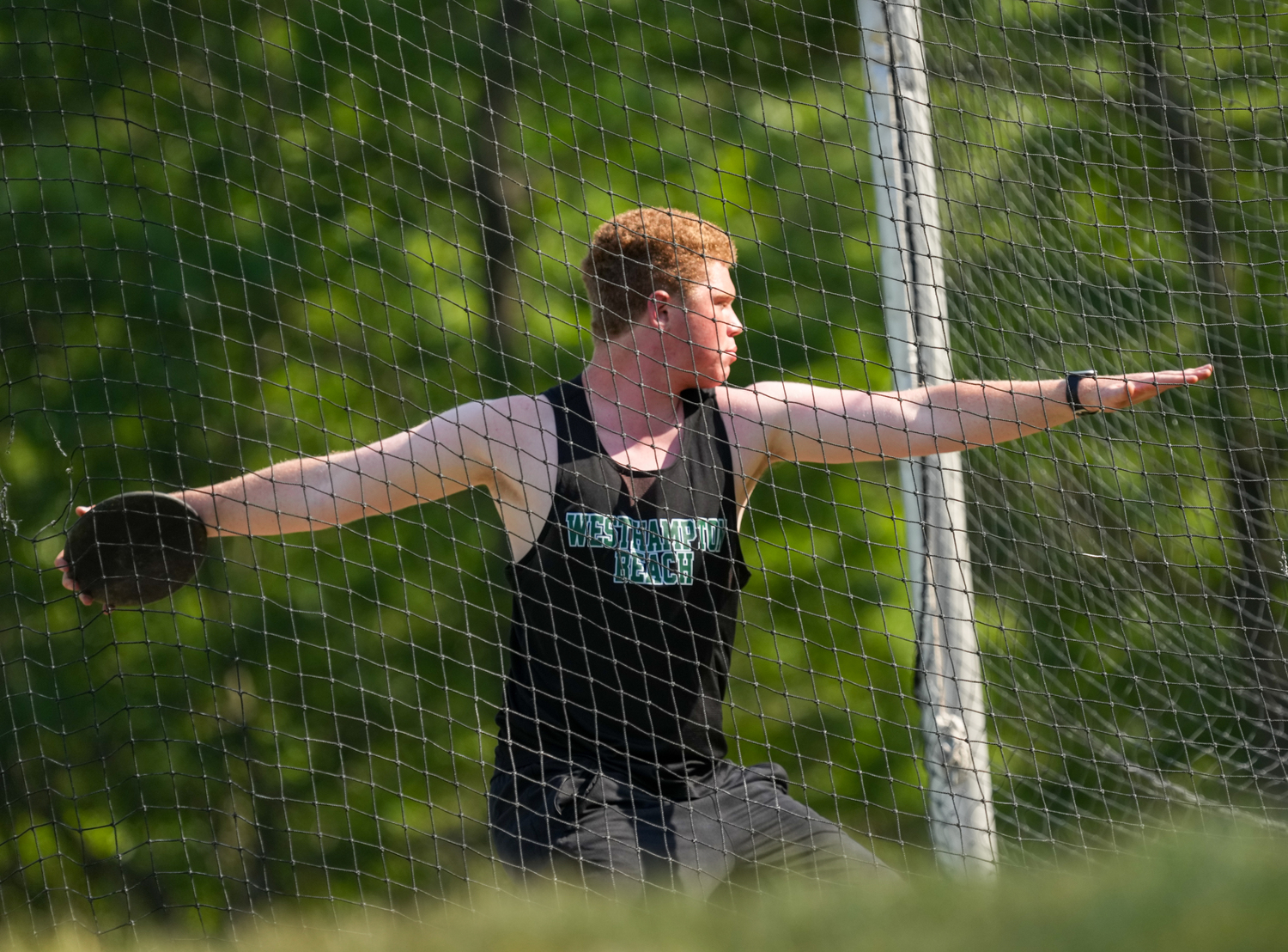 Westhampton Beach junior Jack Hendrickson performs in the discus at the state qualifier.   RON ESPOSITO