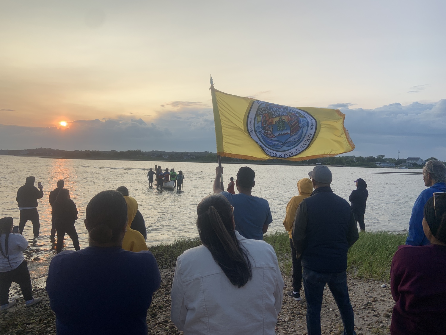 Members of the Shinnecock Nation gathered at Cuffee Beach to welcome home the paddlers after their canoe was swamped in Shinnecock Canal. STEPHEN J. KOTZ