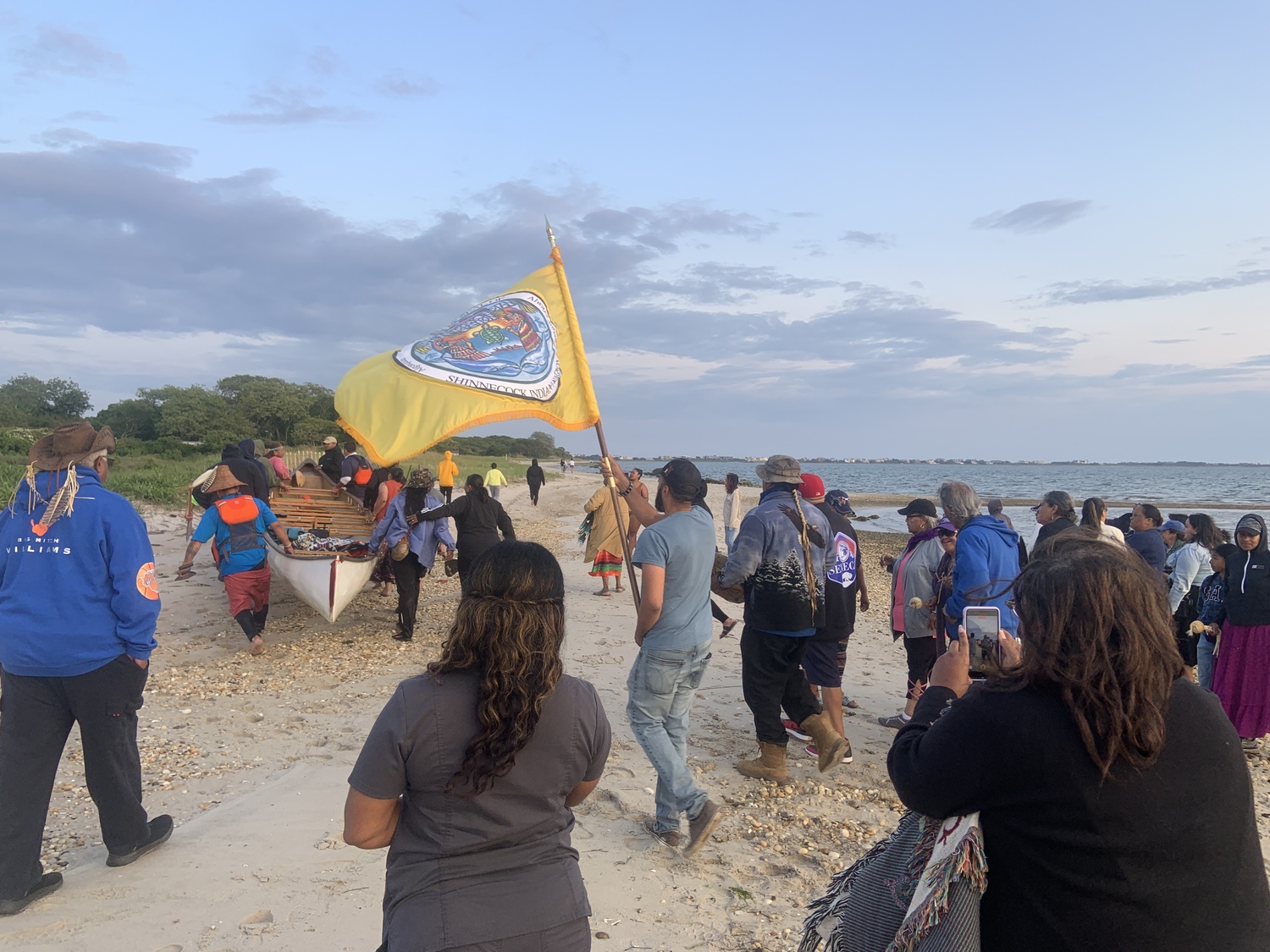 Members of the Shinnecock Nation gathered at Cuffee Beach to welcome home the paddlers after their canoe was swamped in Shinnecock Canal. STEPHEN J. KOTZ