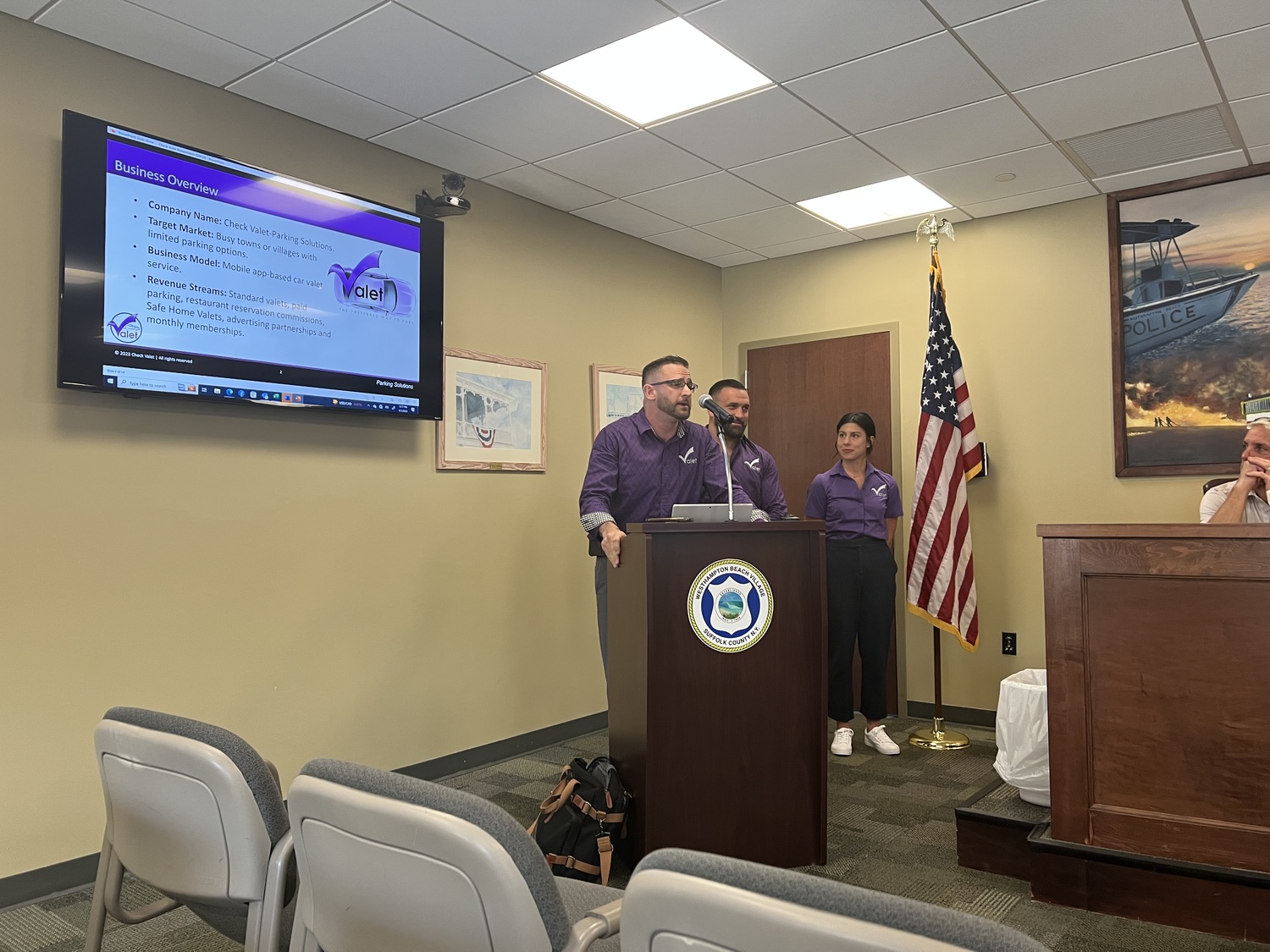 Check-Valet founder and CEO Bryan Monahan, left, and his team, Jake Marino and Maresa Crecca, make a presentation to the Village Board last week. BILL SUTTON