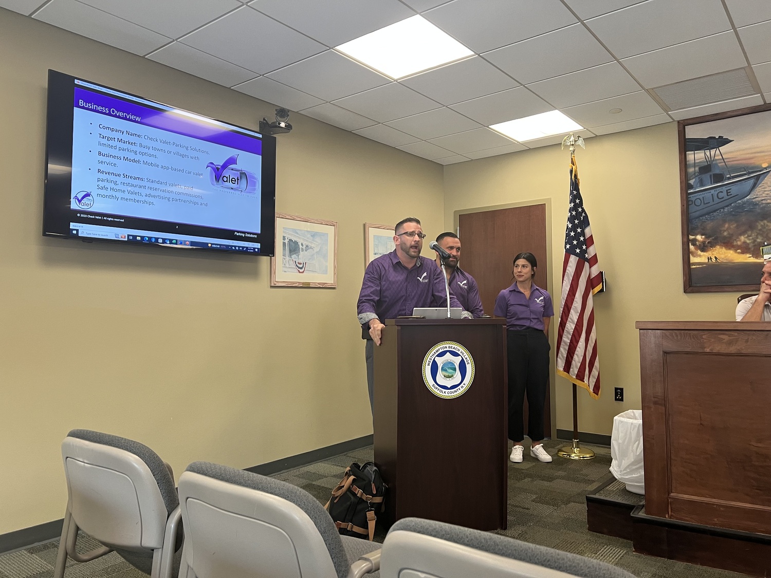 Check-Valet founder and CEO Bryan Monahan, left, and his team, Jake Marino and Maresa Crecca, make a presentation to the Village Board last week. BILL SUTTON