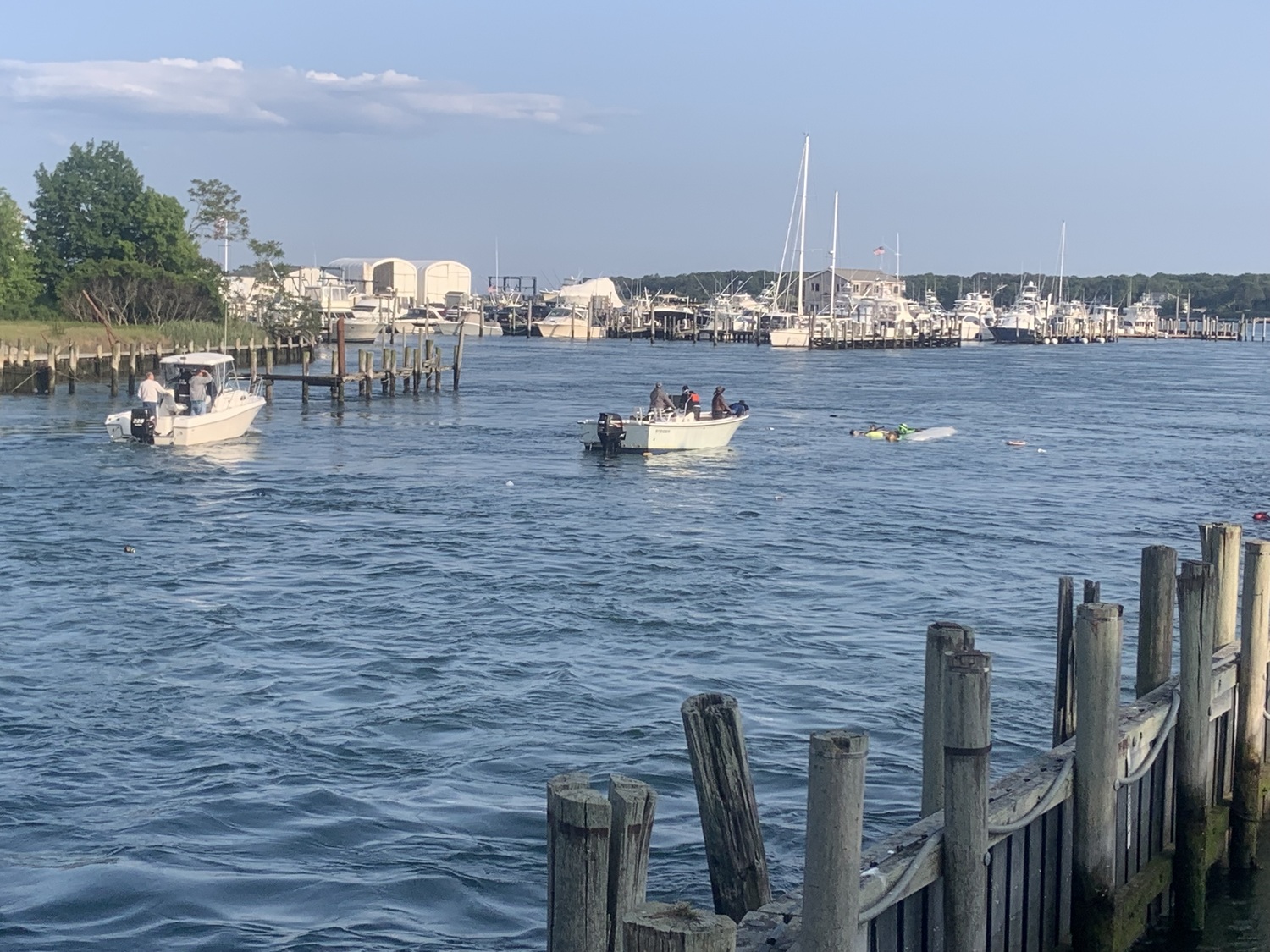 The chase boat helps the team of six who were arriving in the Shinnecock Inlet during a multiday  canoe journey from Boston to New York City. STEPHEN J. KOTZ