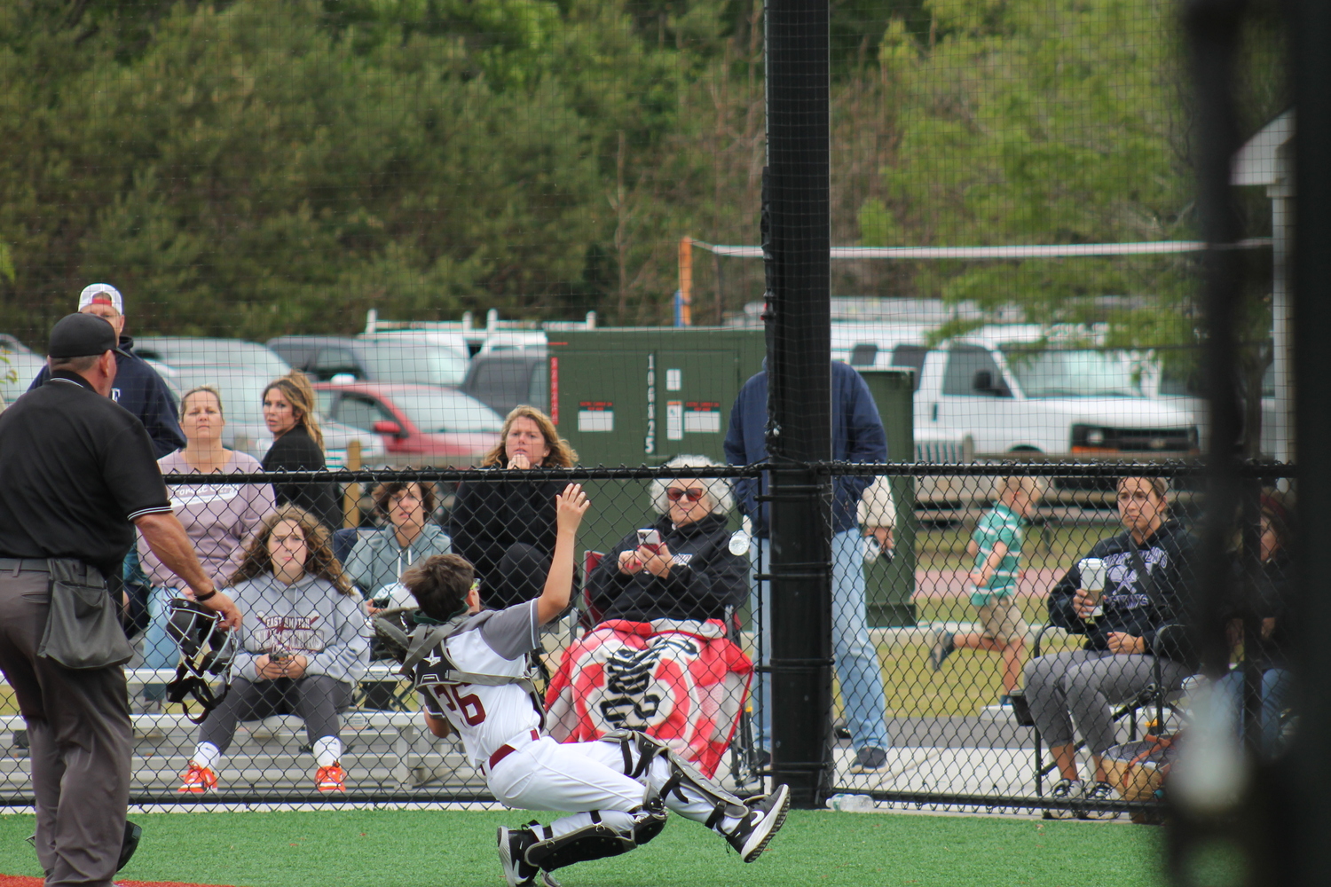 Southampton catcher Matthew Lesta makes a diving grab behind home plate.   KRIS VINSKI