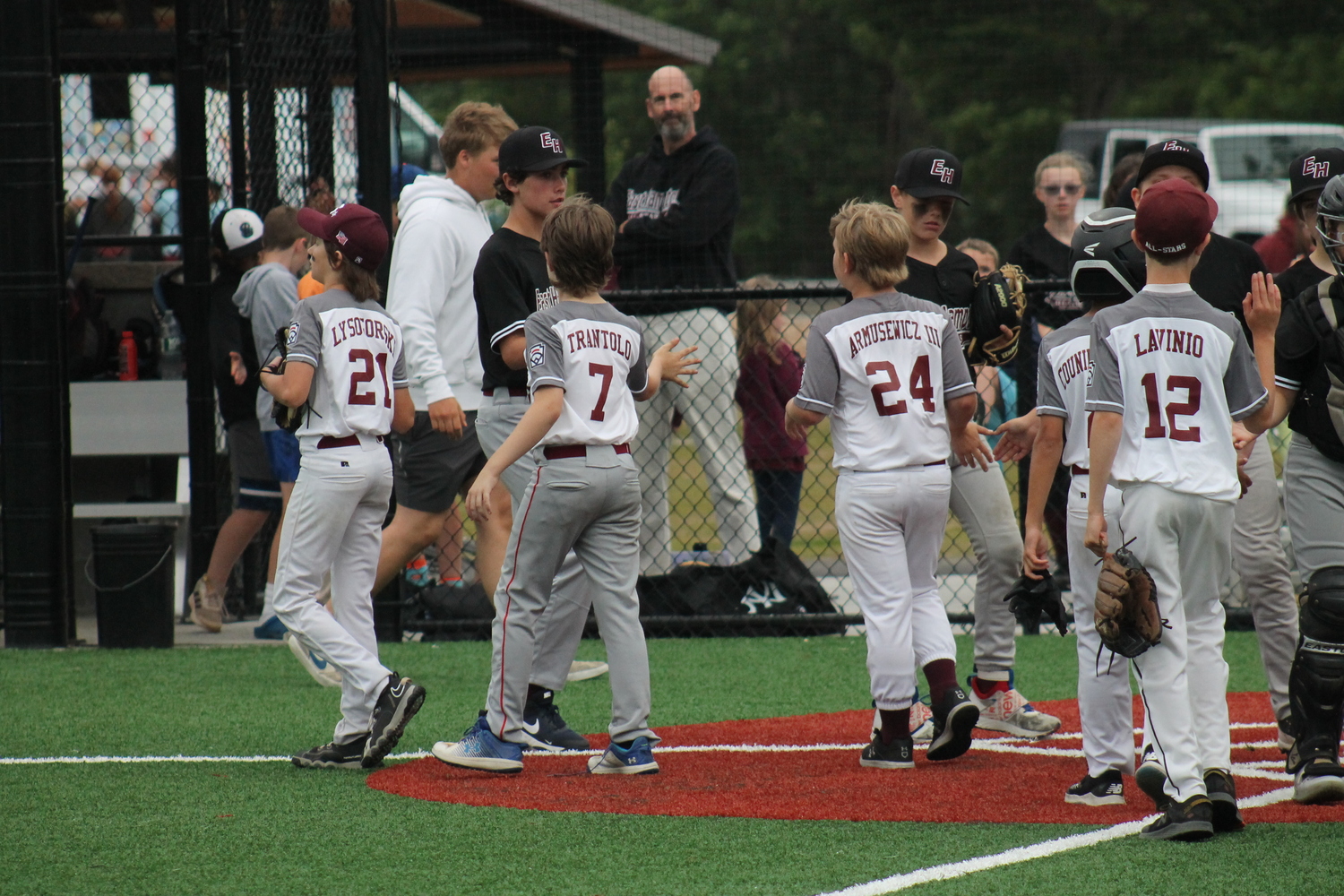 The East Hampton 12U All-Stars shake hands with their Southampton counterparts after a 9-0 victory.  KRIS VINSKI