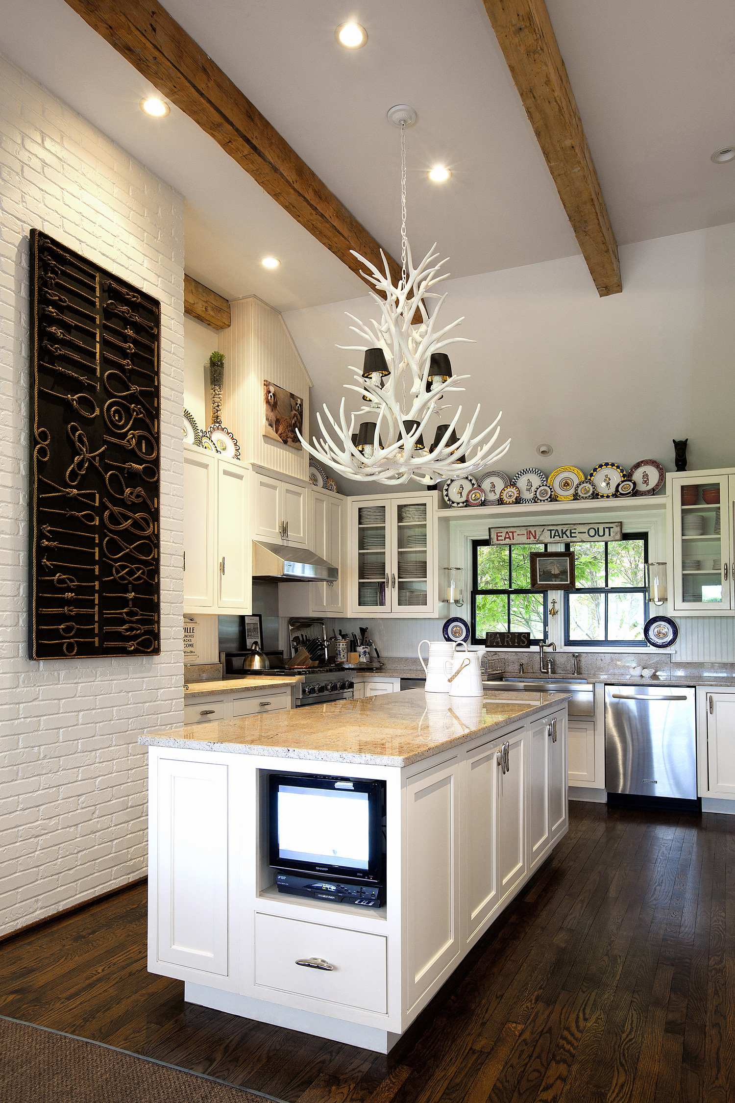 The kitchen features an antler chandelier. DLUXCREATIVE