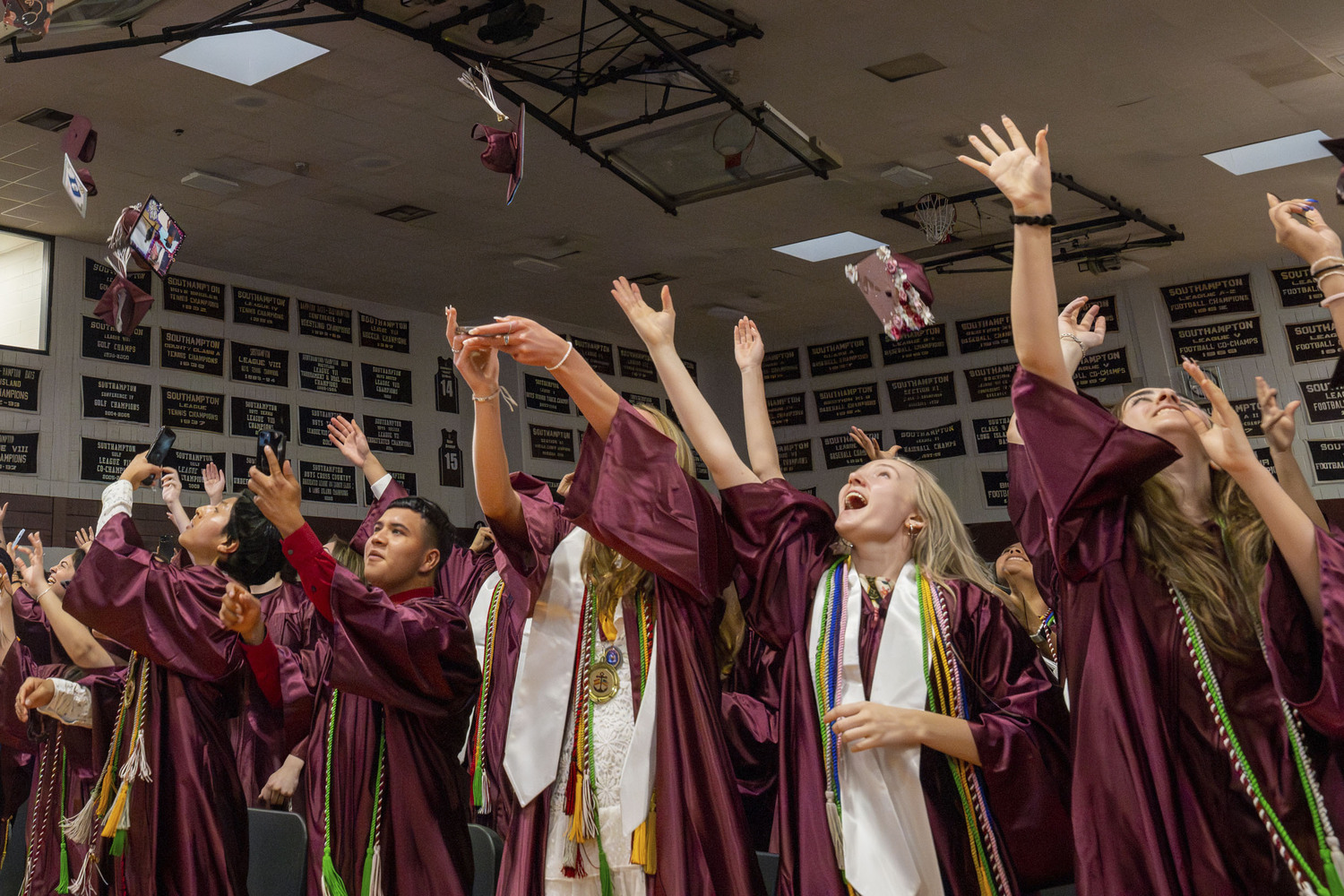 Graduates throw their caps at Southampton High School graduation on June 23.  RON ESPOSITO