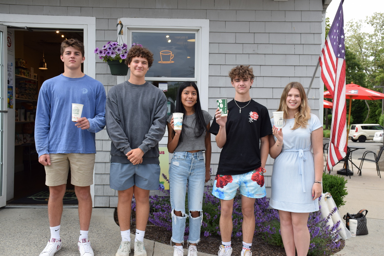 The designs and slogans of five Westhampton Beach High School students are now featured on coffee cups at Hampton Coffee in Westhampton Beach. From left, are Salvatore Fracapane, Theo Grellet-Aumont, Evelyn Reynoso, Aiden Briguglio and Natalie Sadowski.  COURTESY WESTHAMPTON BEACH SCHOOL DISTRICT