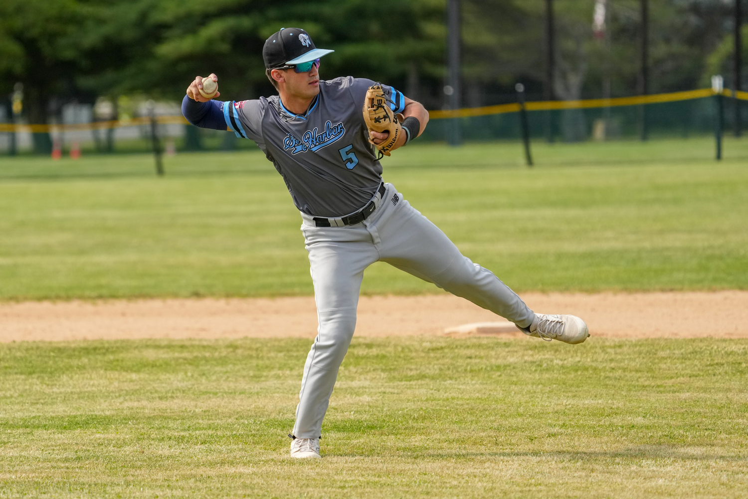 Sag Harbor's Milo Suarez (Dartmouth) throws to first base after fielding a ground ball. RON ESPOSITO