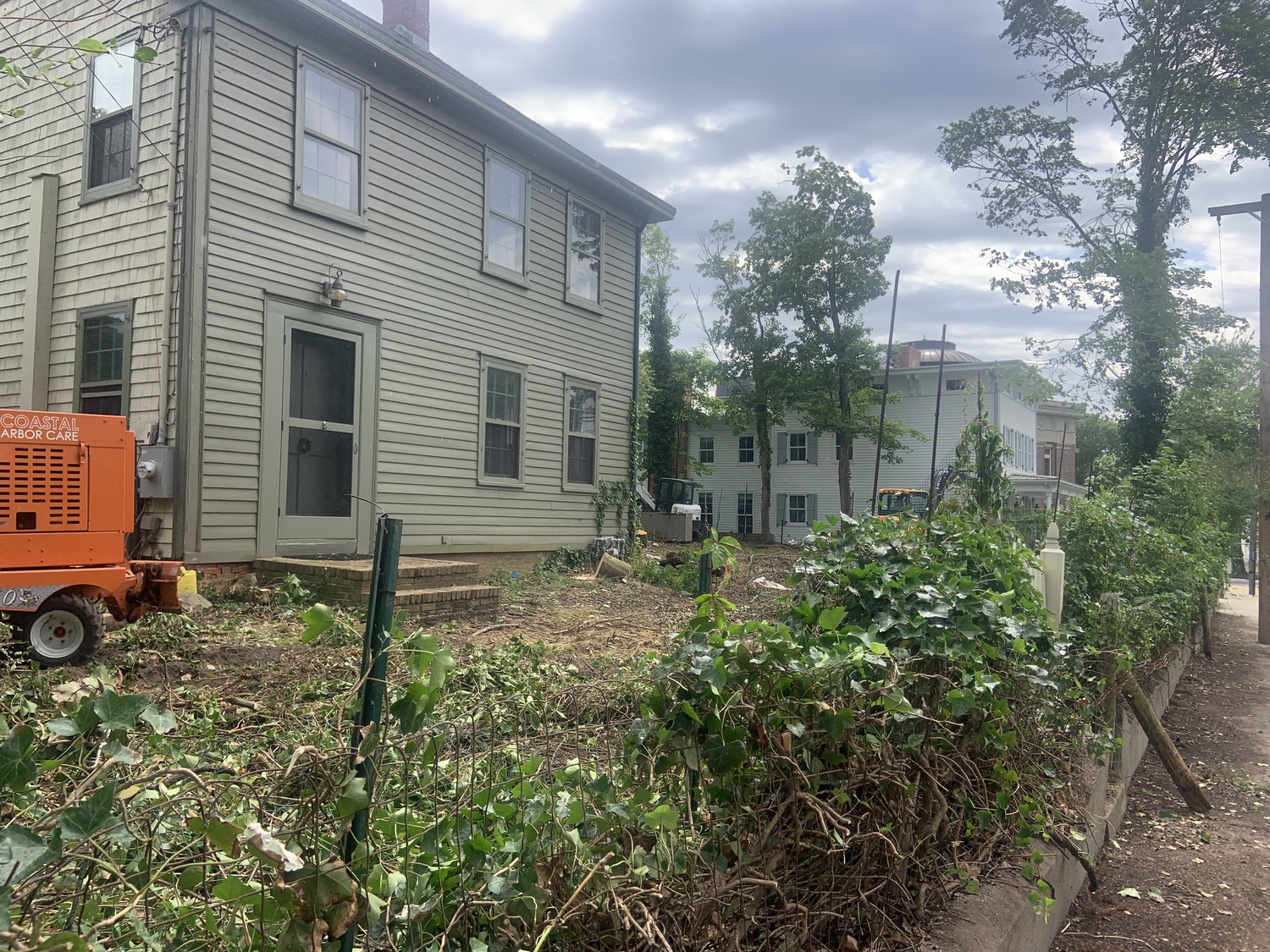 Workers cleared an overgrown lot at 12 Union Street in Sag Harbor in preparation for the construction of an addition. STEPHEN J. KOTZ