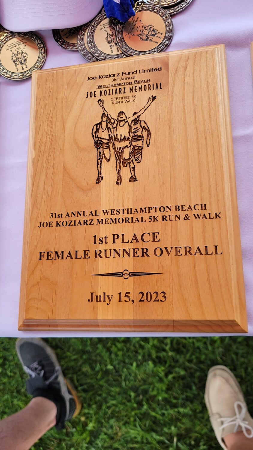 Plaques were given to the first overall male and female runners.    DREW BUDD