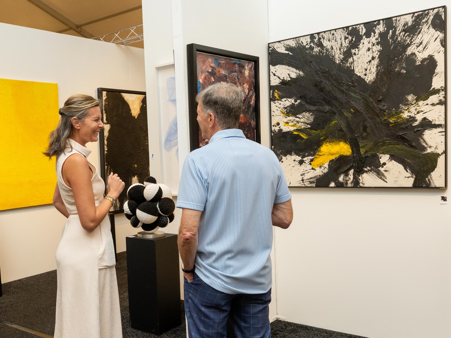 Woman pictured enjoying conversation and art at the fair. RON ESPOSITO.