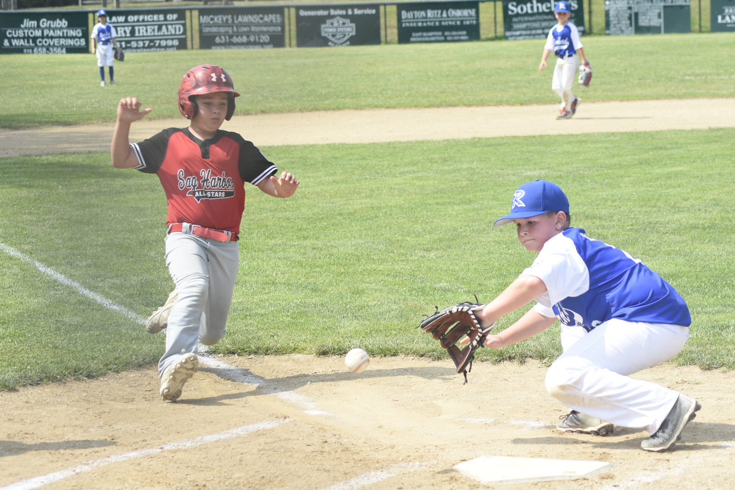 Jace Birdsall slides into home plate trying to score on a passed ball.   DREW BUDD