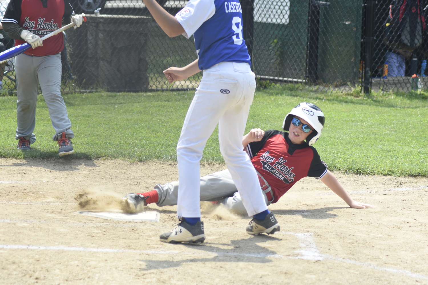 Enzo Mazzeo slides safely into home plate. DREW BUDD