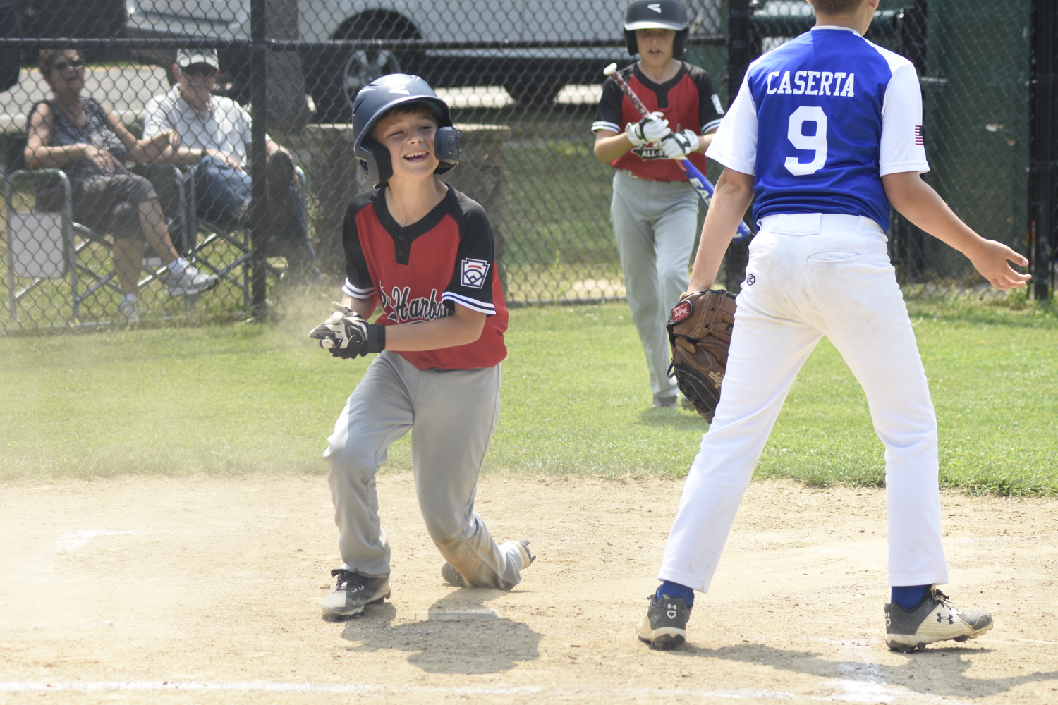 Rowan Dodds smiles after scoring a run late in Saturday's victory over Riverhead.  DREW BUDD