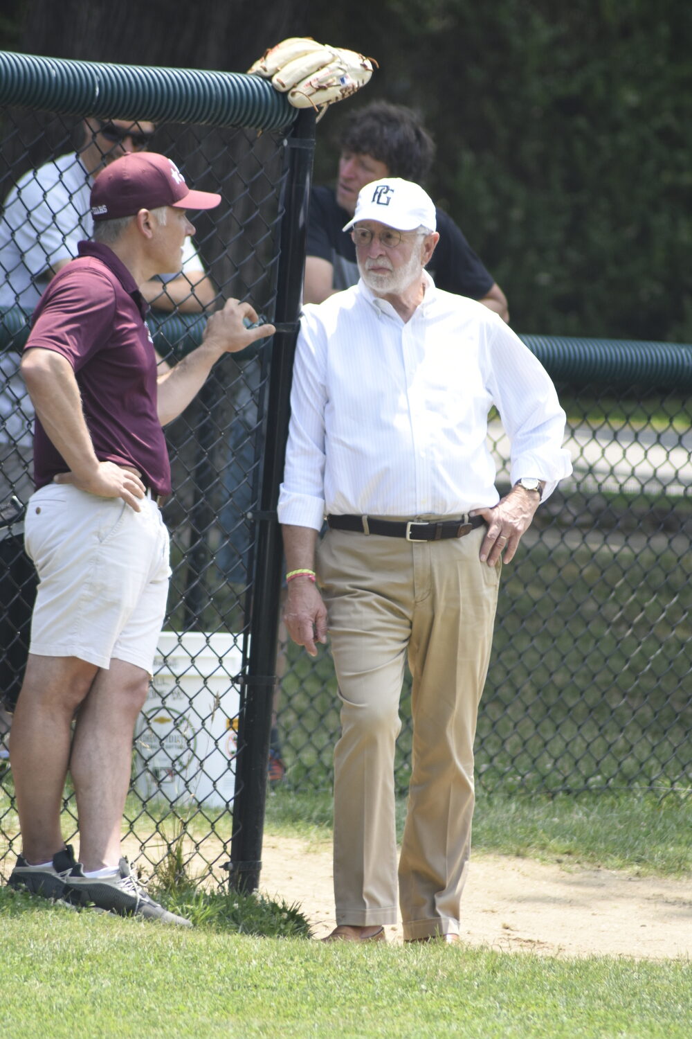 Former U.S. Representative Tim Bishop watching his grandson Nathan and his teammates warm up prior to Saturday's game in Bridgehampton.   DREW BUDD