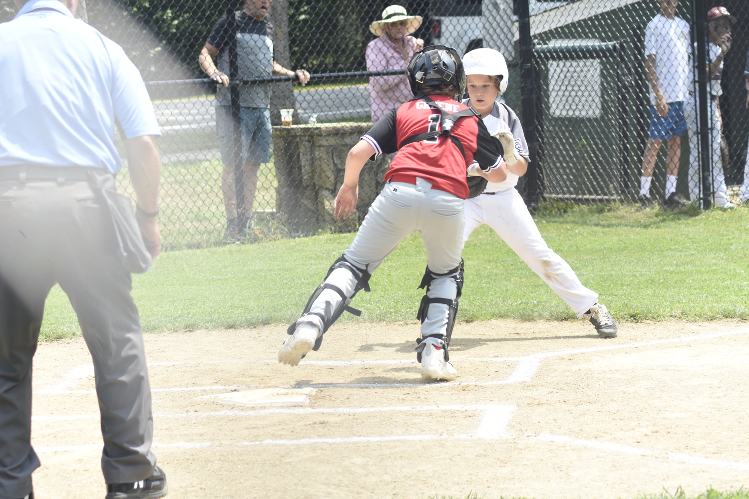 Tre Armusewicz is cut down at the plate by Sag Harbor catcher Ashton Greene.   DREW BUDD