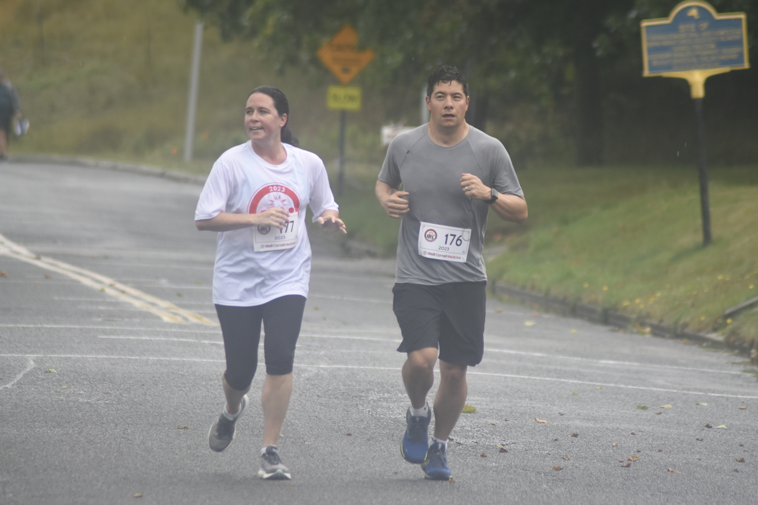 Karen Manley, left, and Edward Eng head toward the finish line of the 3-mile race.   DREW BUDD