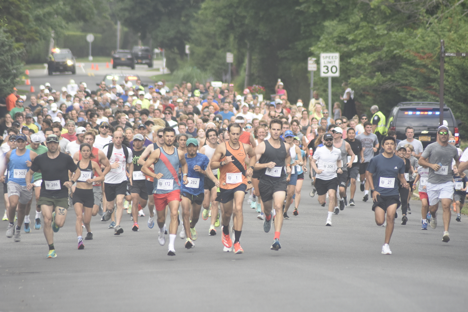 Sergey Avramenko and Jeffrey Ares lead the pack of runners at the start of the 31st annual Joe Koziarz Memorial 5K in Westhampton Beach on Saturday morning.   DREW BUDD