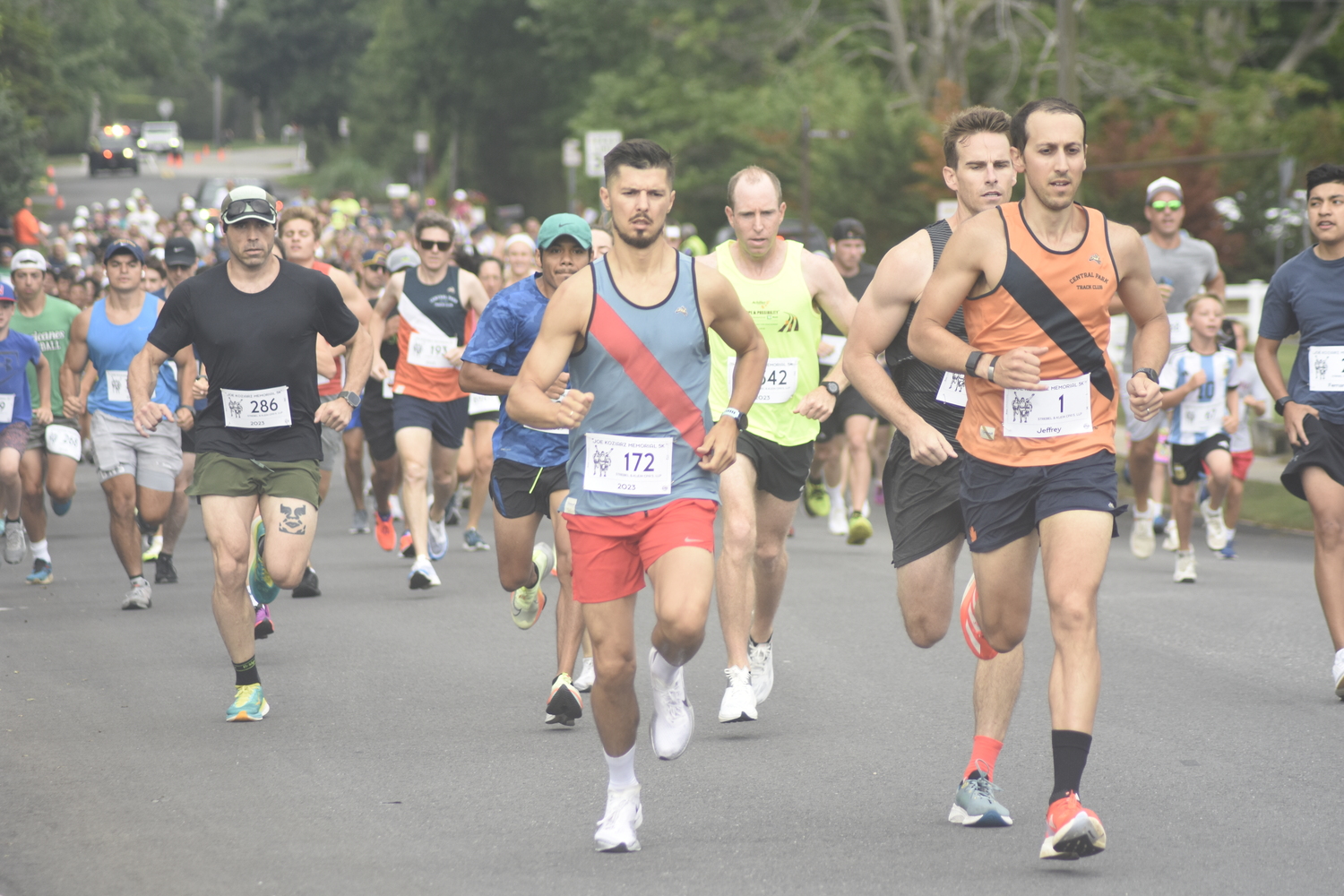 Sergey Avramenko and Jeffrey Ares lead the pack of runners at the start of the 31st annual Joe Koziarz Memorial 5K in Westhampton Beach on Saturday morning.   DREW BUDD