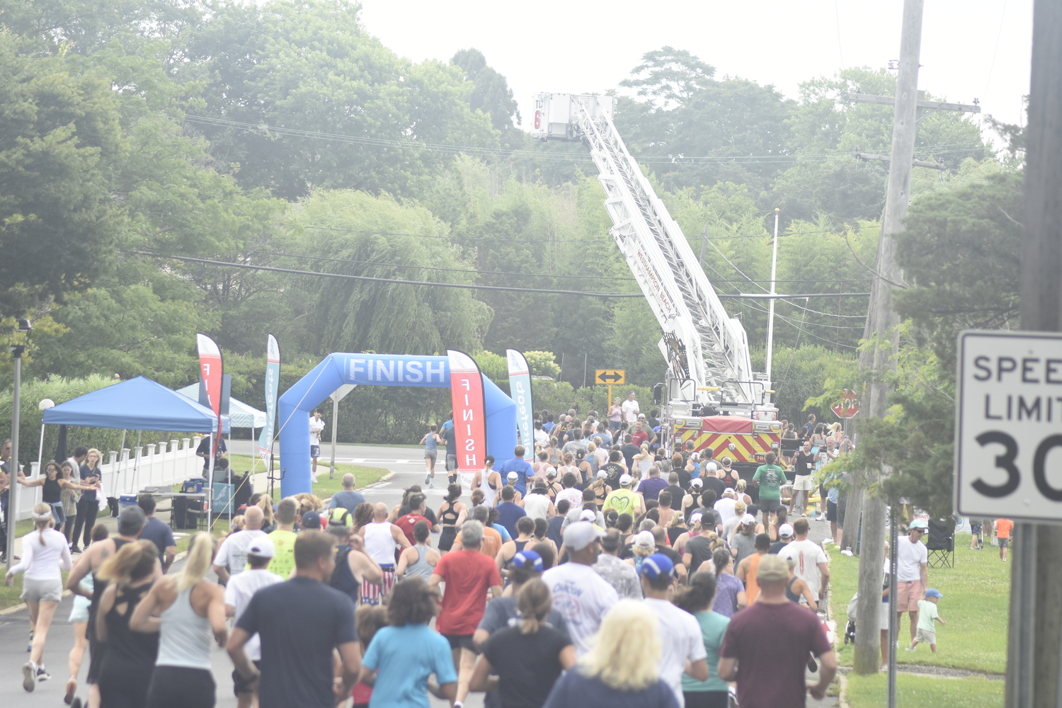 Runners and walkers head east on Stevens Lane before making a right on Library Avenue.    DREW BUDD