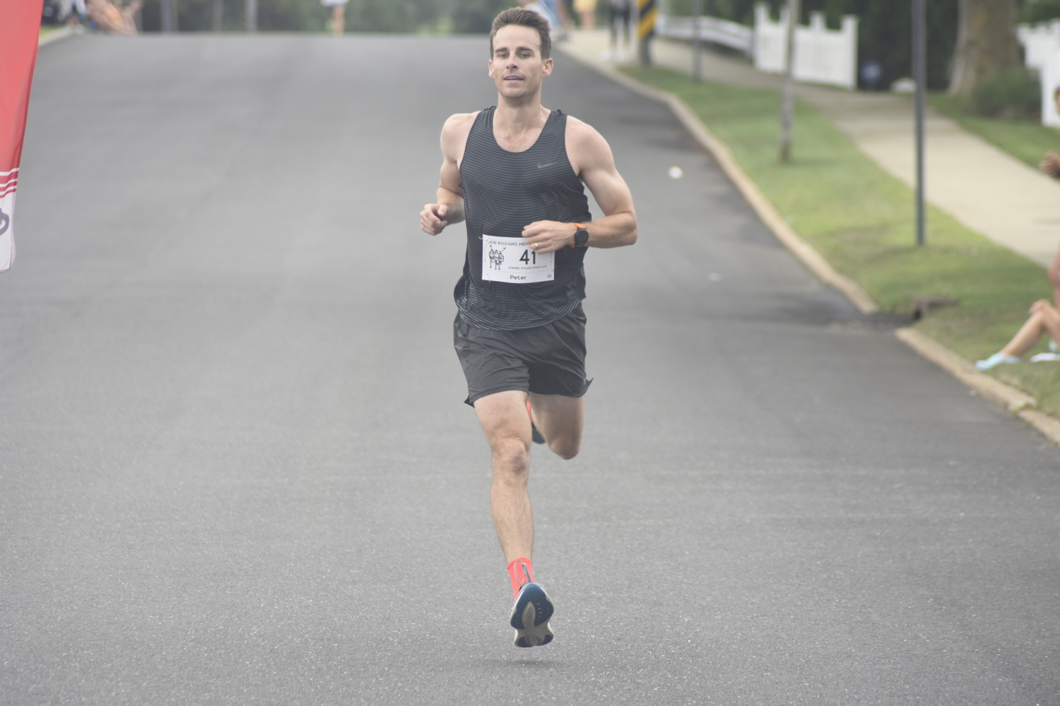 Peter Bartlett crosses the finish line in third place.   DREW BUDD