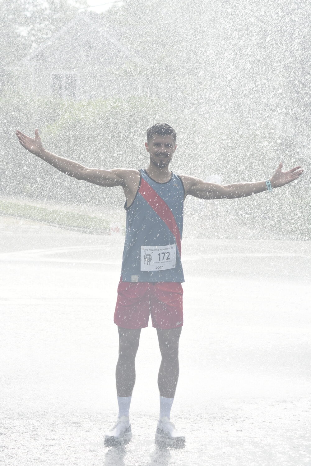 Overall champion Sergey Avramenko cools off in the shower provided by the Westhampton Beach Fire Department.   DREW BUDD