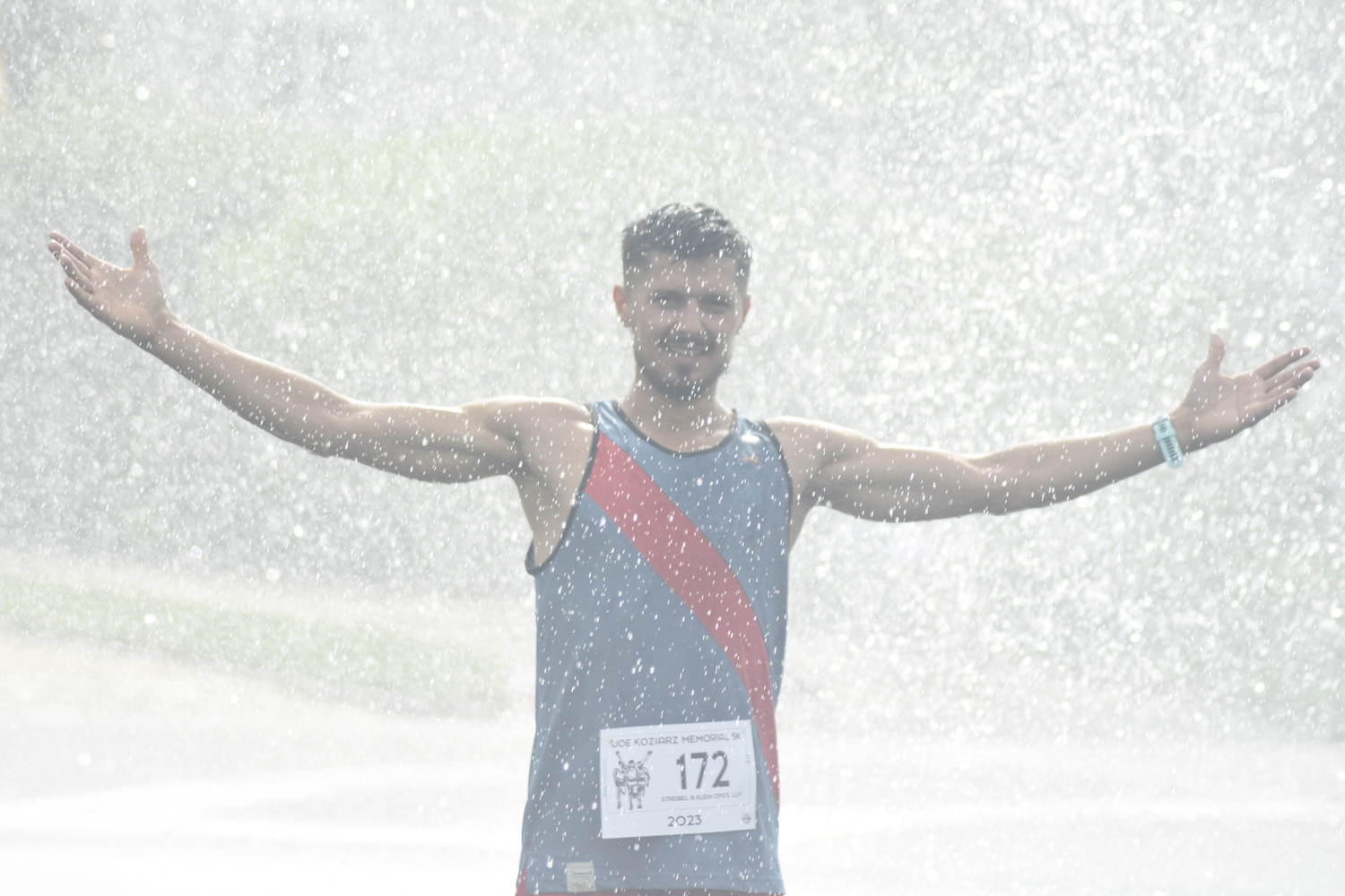 Overall champion Sergey Avramenko cools off in the shower provided by the Westhampton Beach Fire Department.   DREW BUDD