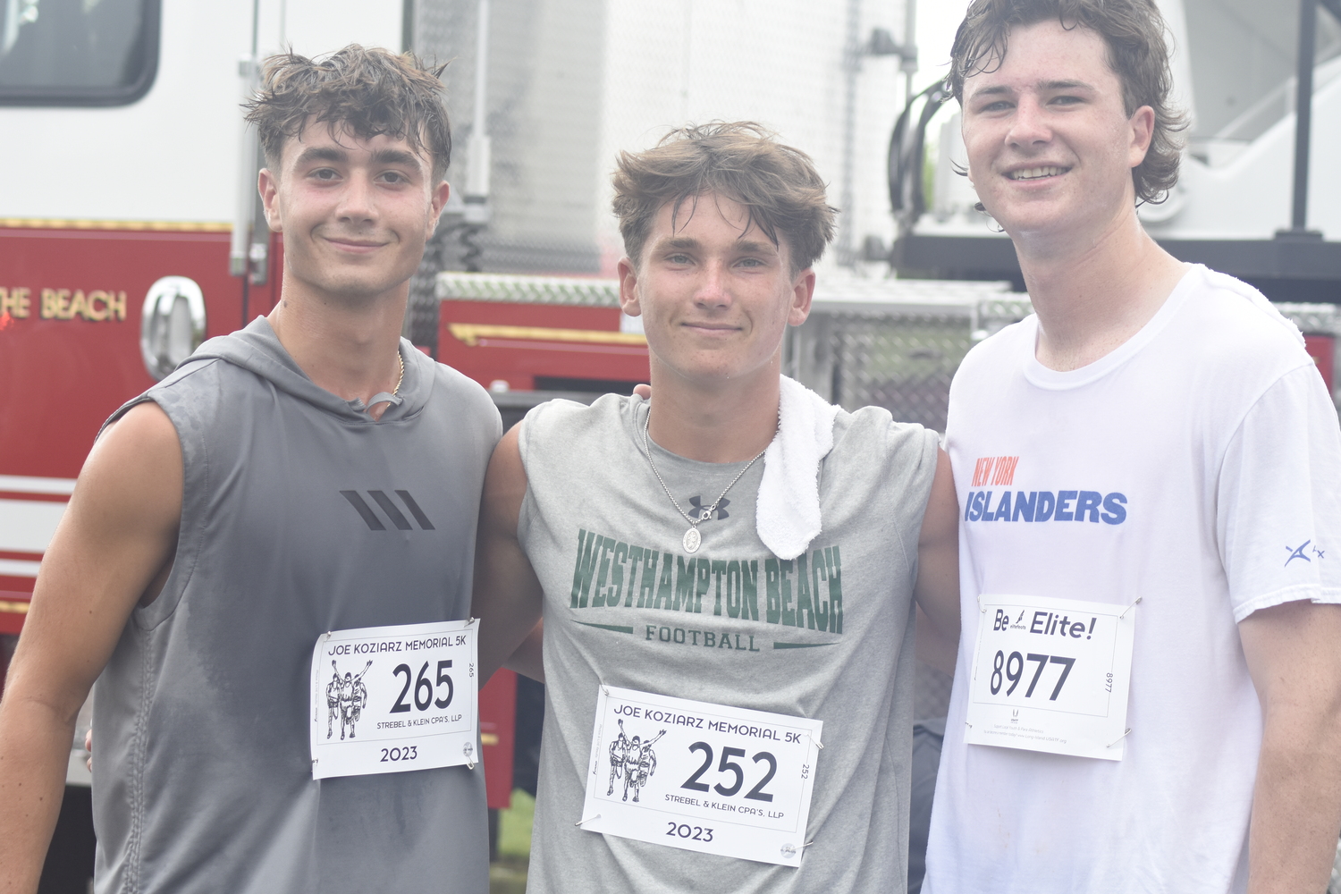 Westhampton Beach varsity football players Will Gambino, left, and Heath Sumwalt and varsity volleyball player Conor Farnan.   DREW BUDD