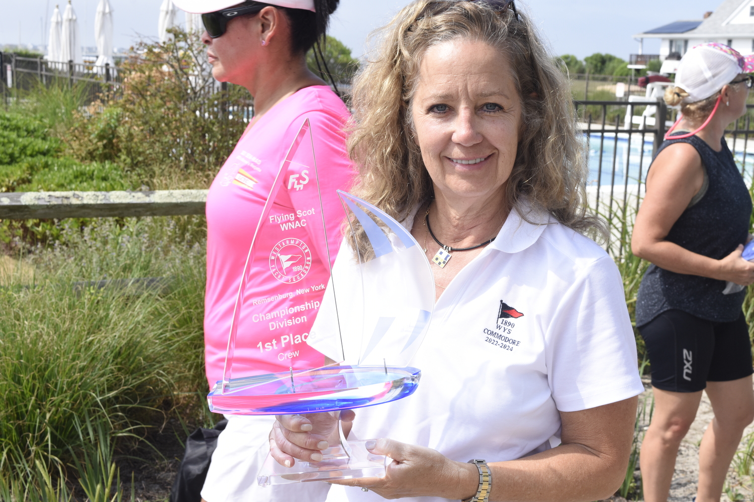 Westhampton Yacht Squadron Commodore Sundy Schermeyer holds up the top prize for the winning team this past weekend.   DREW BUDD