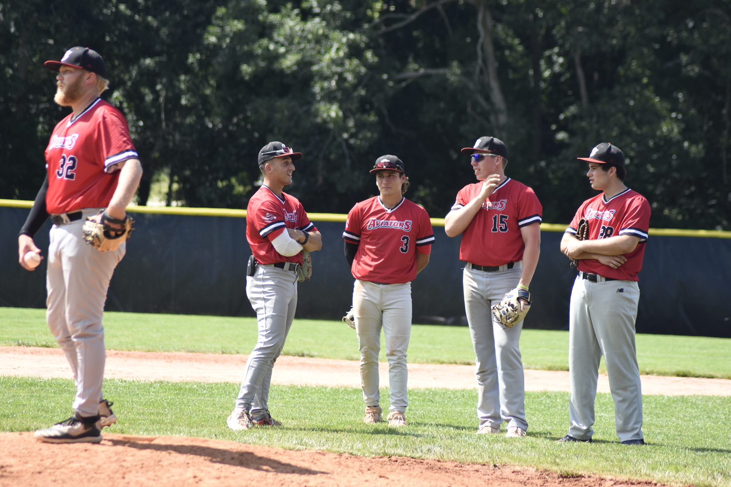 The Aviators watch on as teammate Atley Jacome takes his warm up pitches. Westhampton is the top seed going into this week’s playoffs and began play with the Southampton Breakers in one of the semifinal series that started on Tuesday.   DREW BUDD