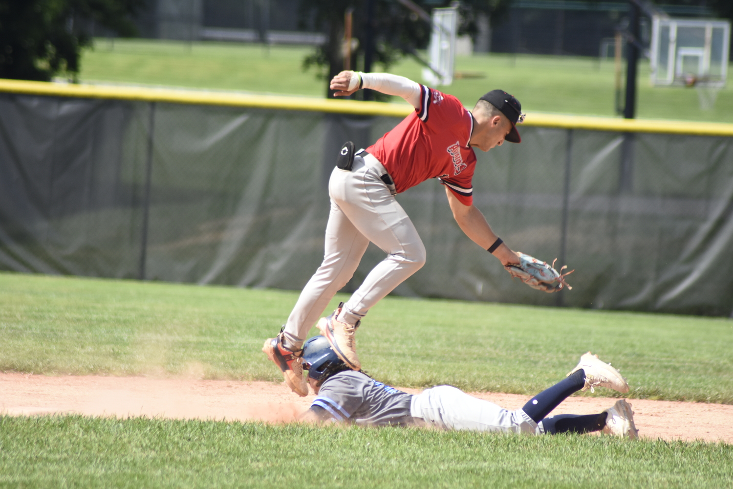 Westhampton's Matt Torres (Dickinson) tries to get a tag down on Whaler T.J. Werner (Farleigh Dickinson) who steals second base.    DREW BUDD