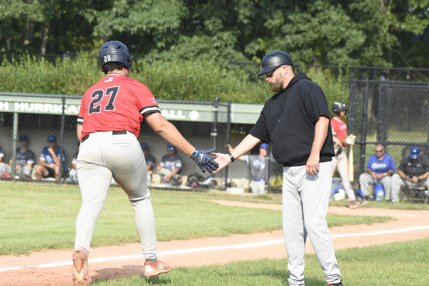 Tyler Smith (Saint Peters) gets congratulated by manager Jason Jacome as he rounds third on his solo home run that brought Westhampton within one run of the Breakers' lead.   DREW BUDD