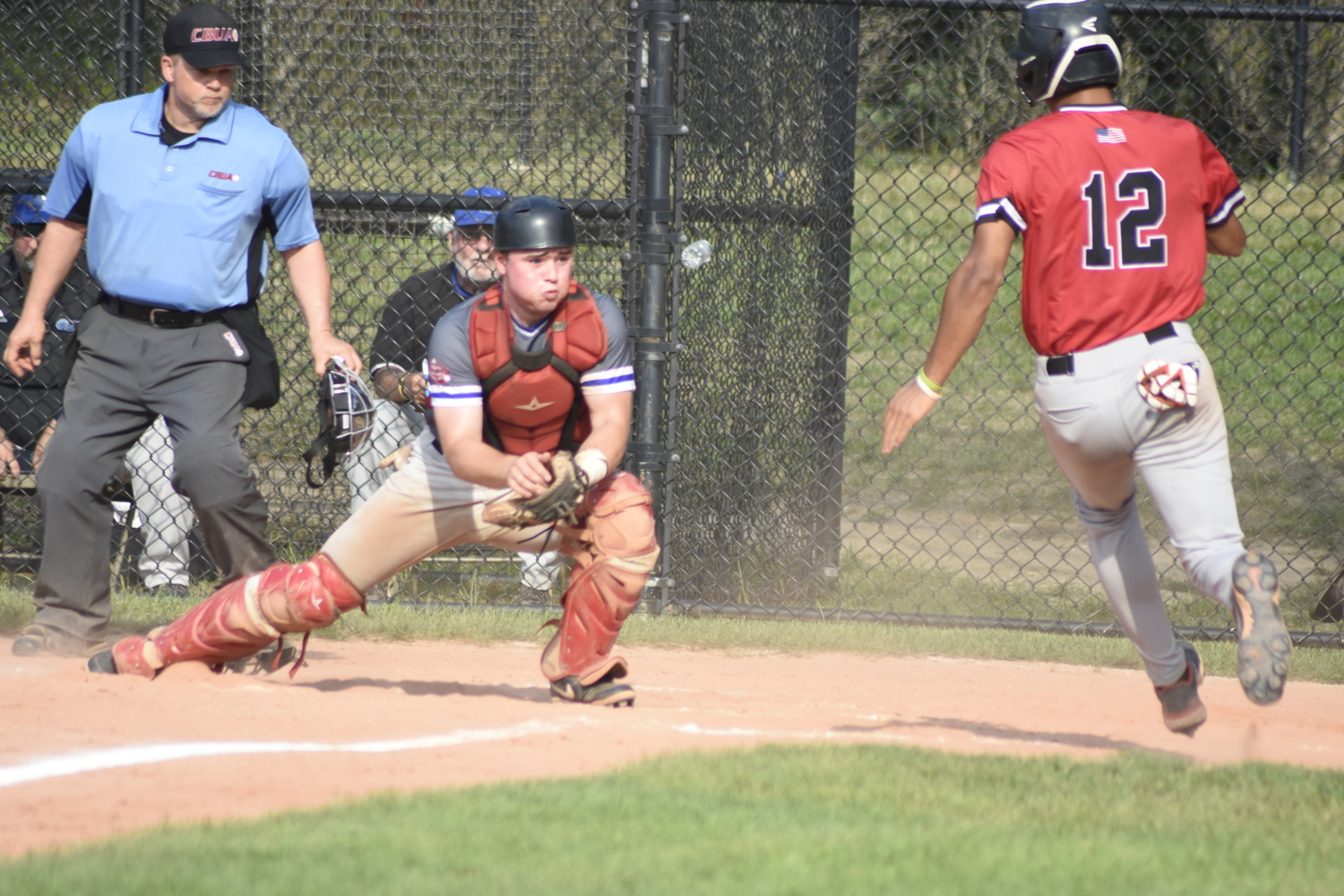 Breakers catcher Ty Gilligan (Dominican) receives a throw and goes to tag Aviator Luke Mistone (Cal State Fullerton) trying to score from second base.   DREW BUDD