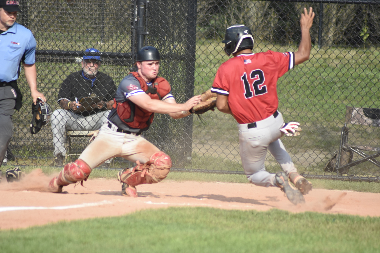 Breakers catcher Ty Gilligan (Dominican) goes to tag Aviator Luke Mistone (Cal State Fullerton) trying to score from second base. Gilligan initially dropped the ball but reapplied the tag to Mistone and got what was at the time a big out, keeping it a one-run game.  DREW BUDD