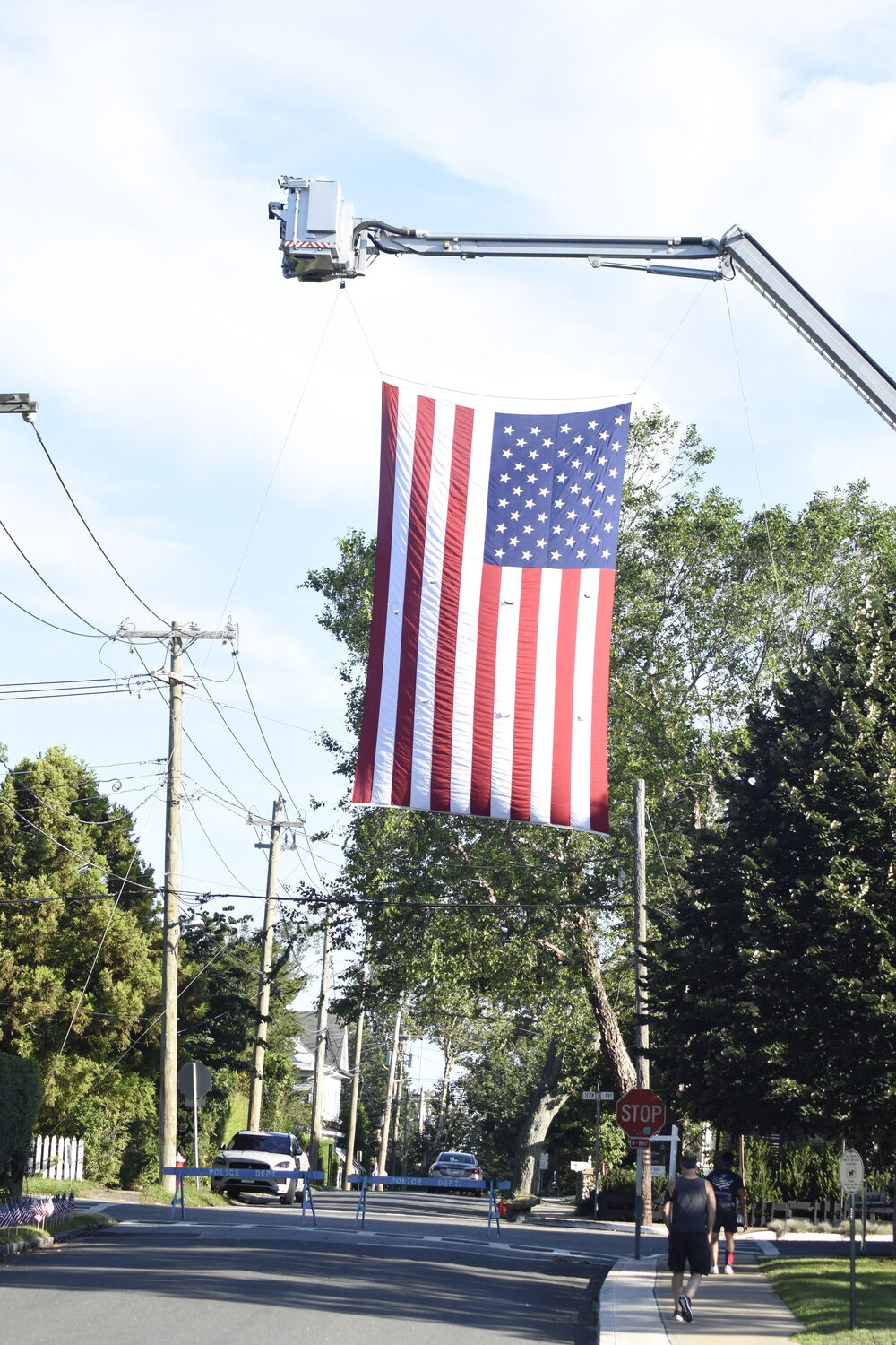 An American flag sat above the intersection of Jermain Avenue and Division Street where runners passed under on their way out at the start and their way back in for the the finish.   DREW BUDD