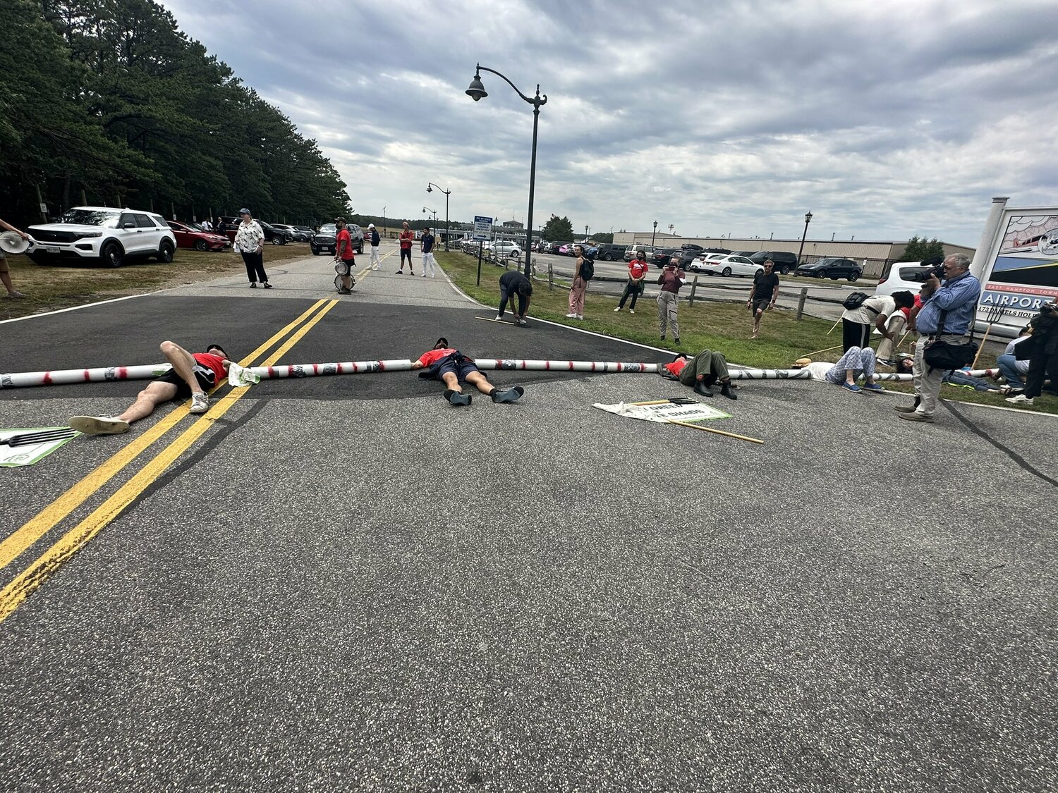 Protesters attempted to block access to East Hampton Airport on Friday afternoon, to protest the outsized contribution that private aircraft usage has on climate change. 
MARGARET KLEIN