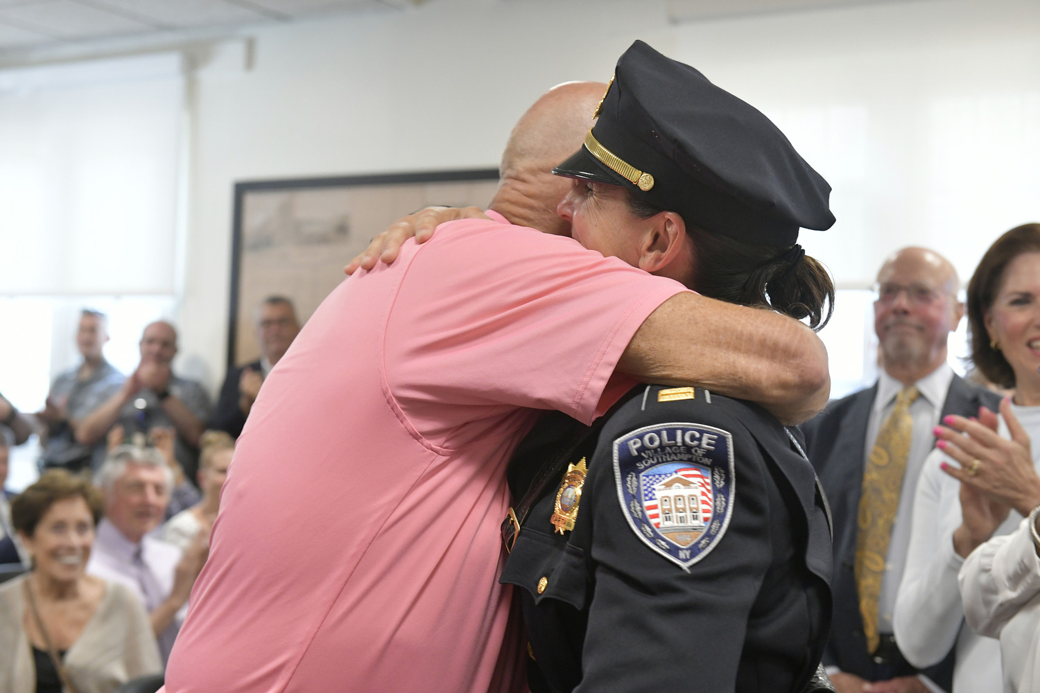 Captain Suzanne Hurteau hugs former Southampton Village Police Chief James Sherry after being sworn in as the new Chief on Monday afternoon at the organizational meeting at Southampton Village Hall.    DANA SHAW