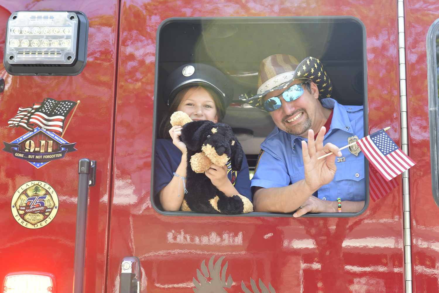 Flanders Fire Department Captain Chris Doscinski and he daughter Josie during the Southampton July 4th parade.