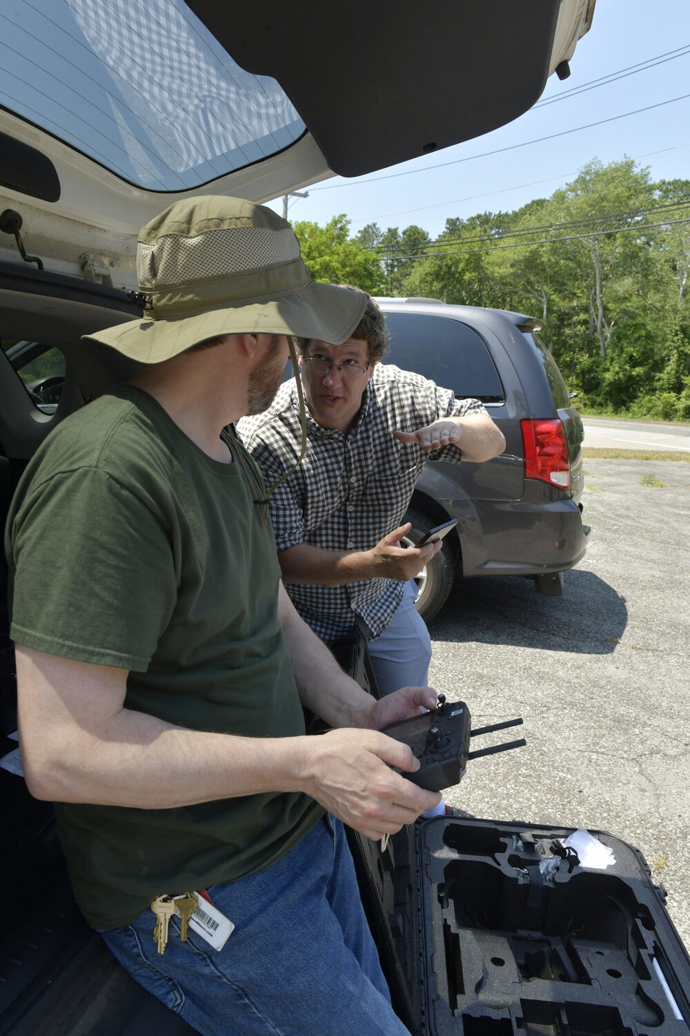 John Gross and Doug Gallaway, assistant professors from Farmingdale State College,  prepare to launch the drone over Wildwood Lake.    DANA SHAW