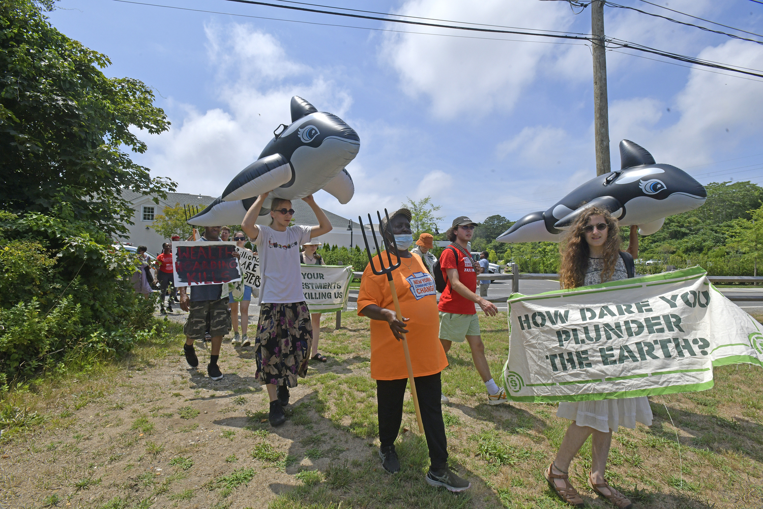 The group marches with members of the Shinnecock Nation to the Shinnecock Canal in Hampton Bays on Saturday.  DANA SHAW