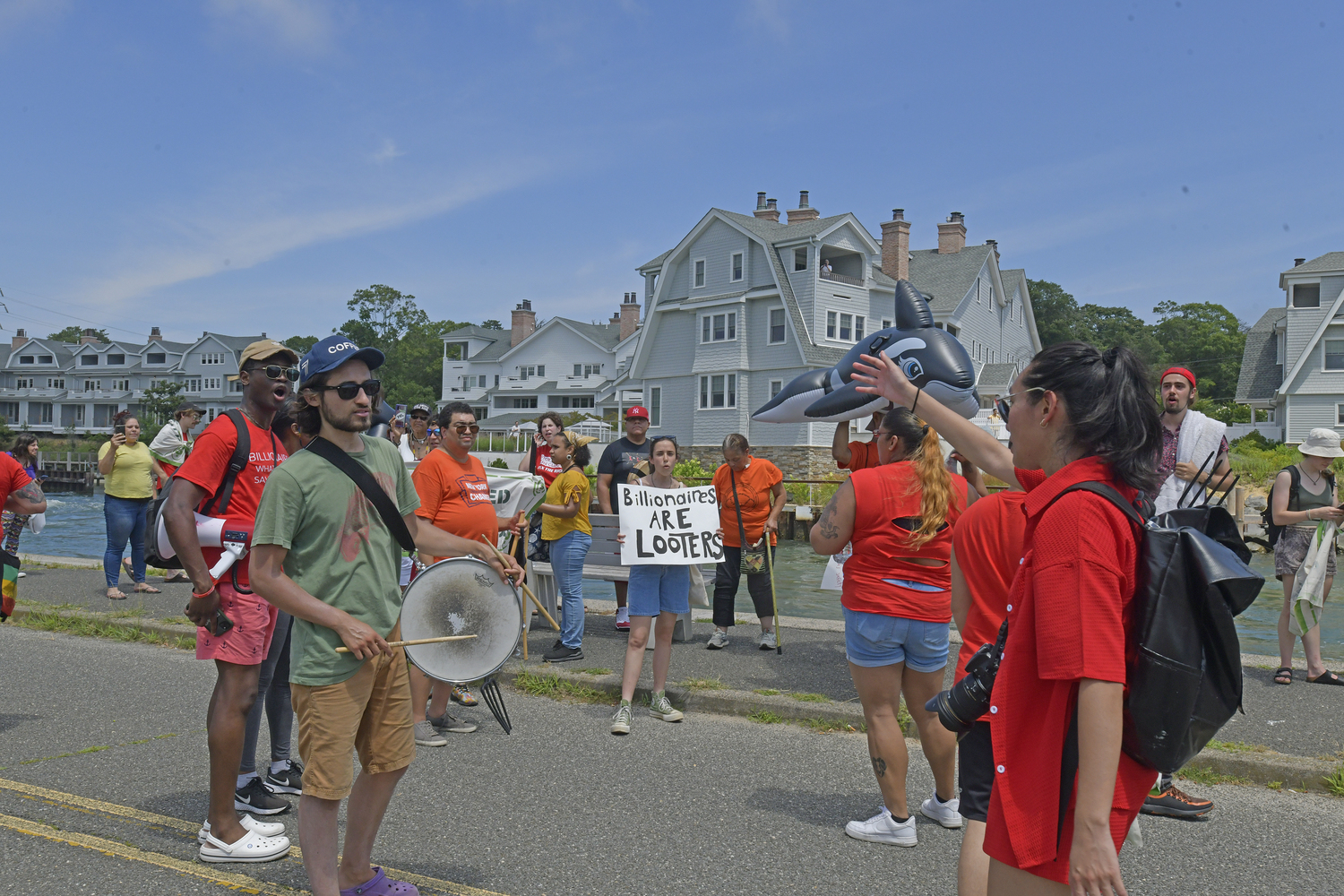 The group marches with members of the Shinnecock Nation to the Shinnecock Canal in Hampton Bays on Saturday.  DANA SHAW