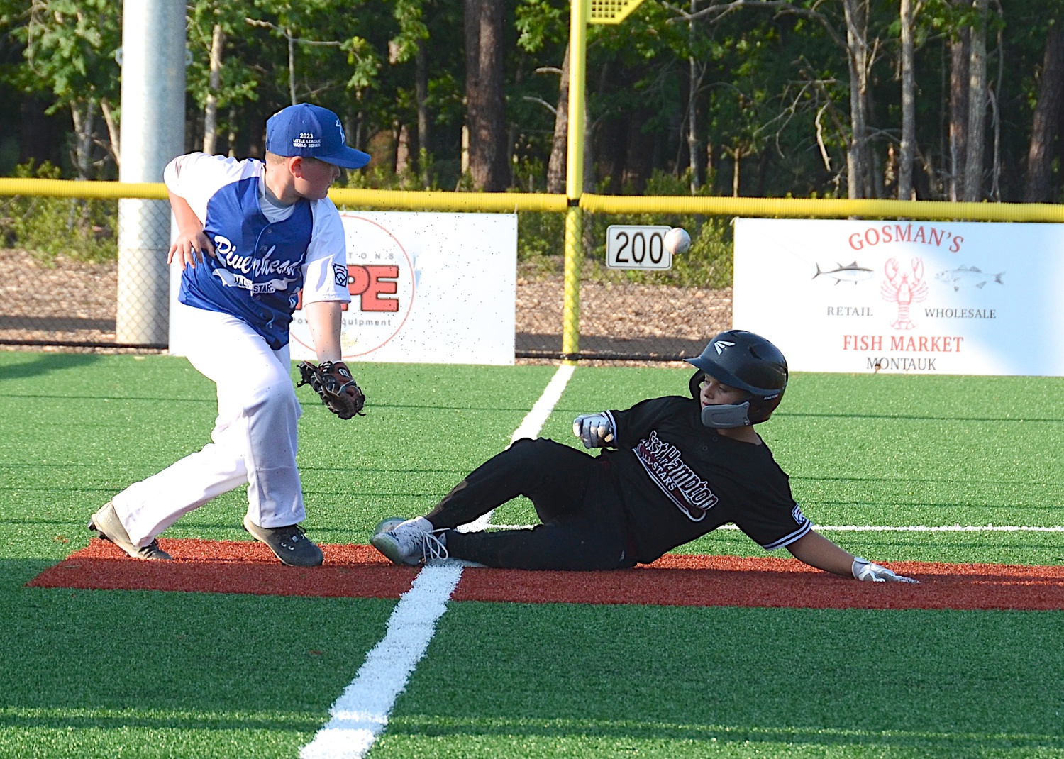 Griffin Page slides in safely at third base. 
KYRIL BROMLEY