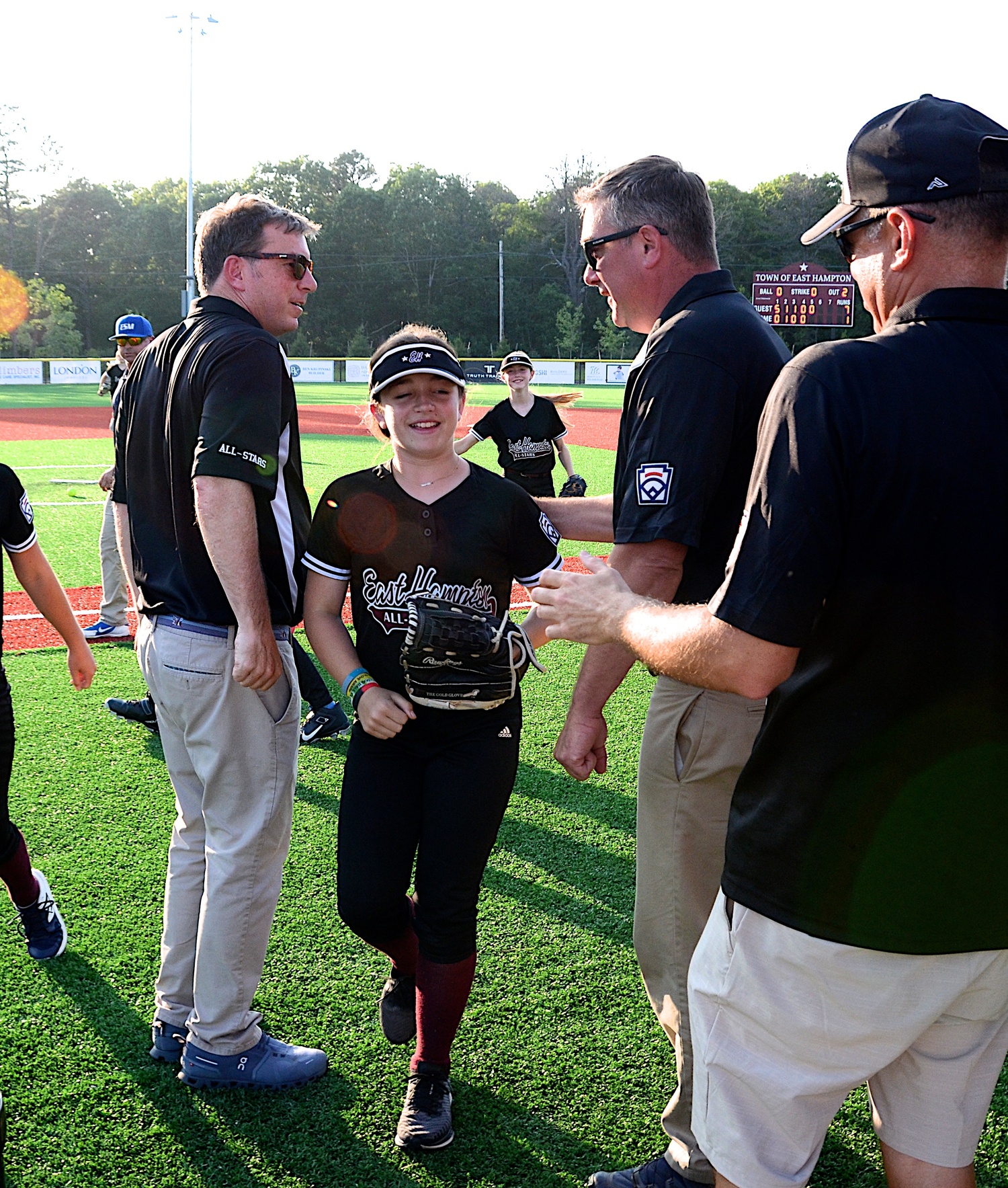 East Hampton's 12U softball All-Stars get congratulated by coaches after their victory over Eastport-South Manor on Thursday, June 29.   KYRIL BROMLEY